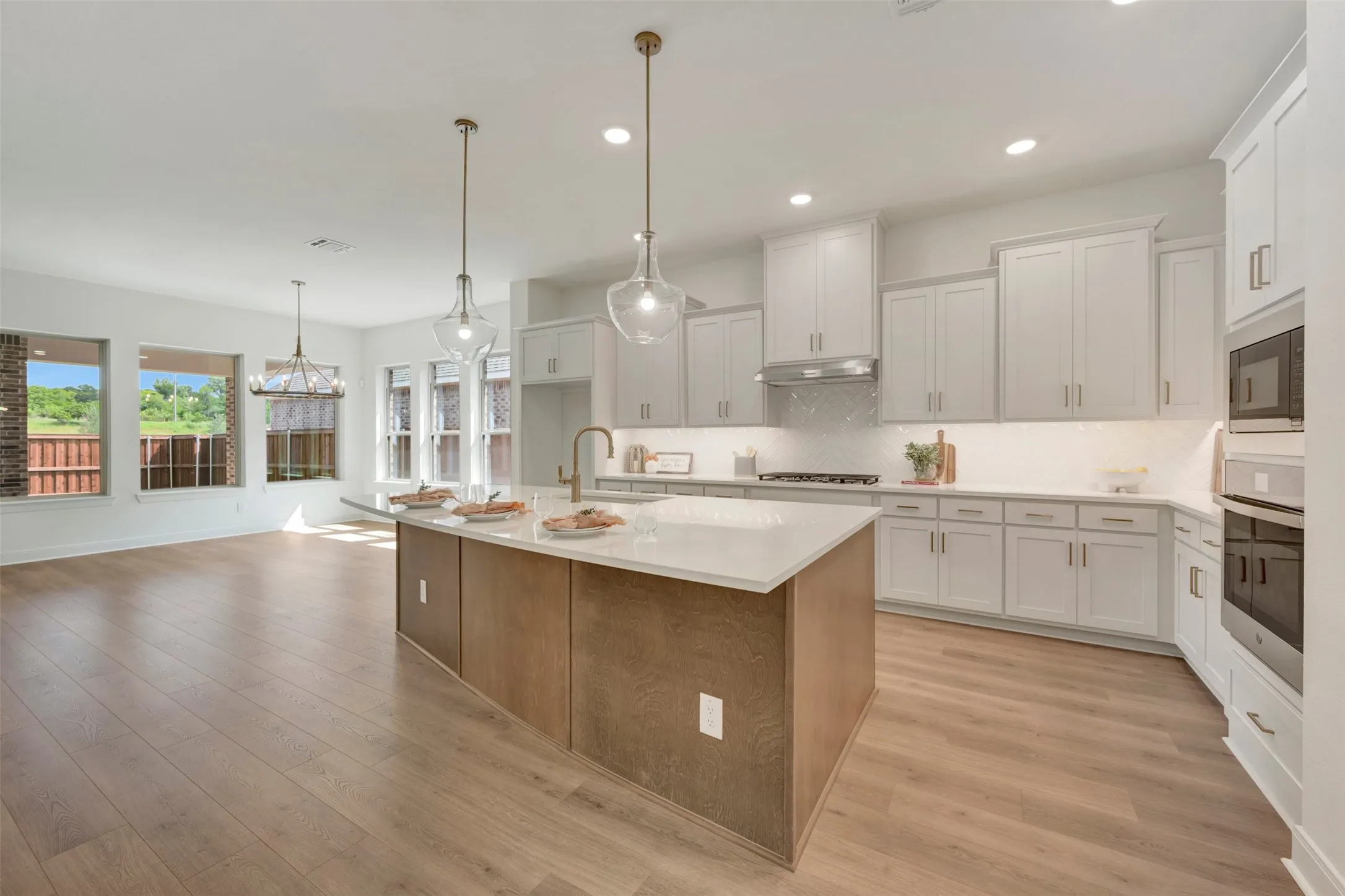 Open-concept living space featuring wood-finish flooring