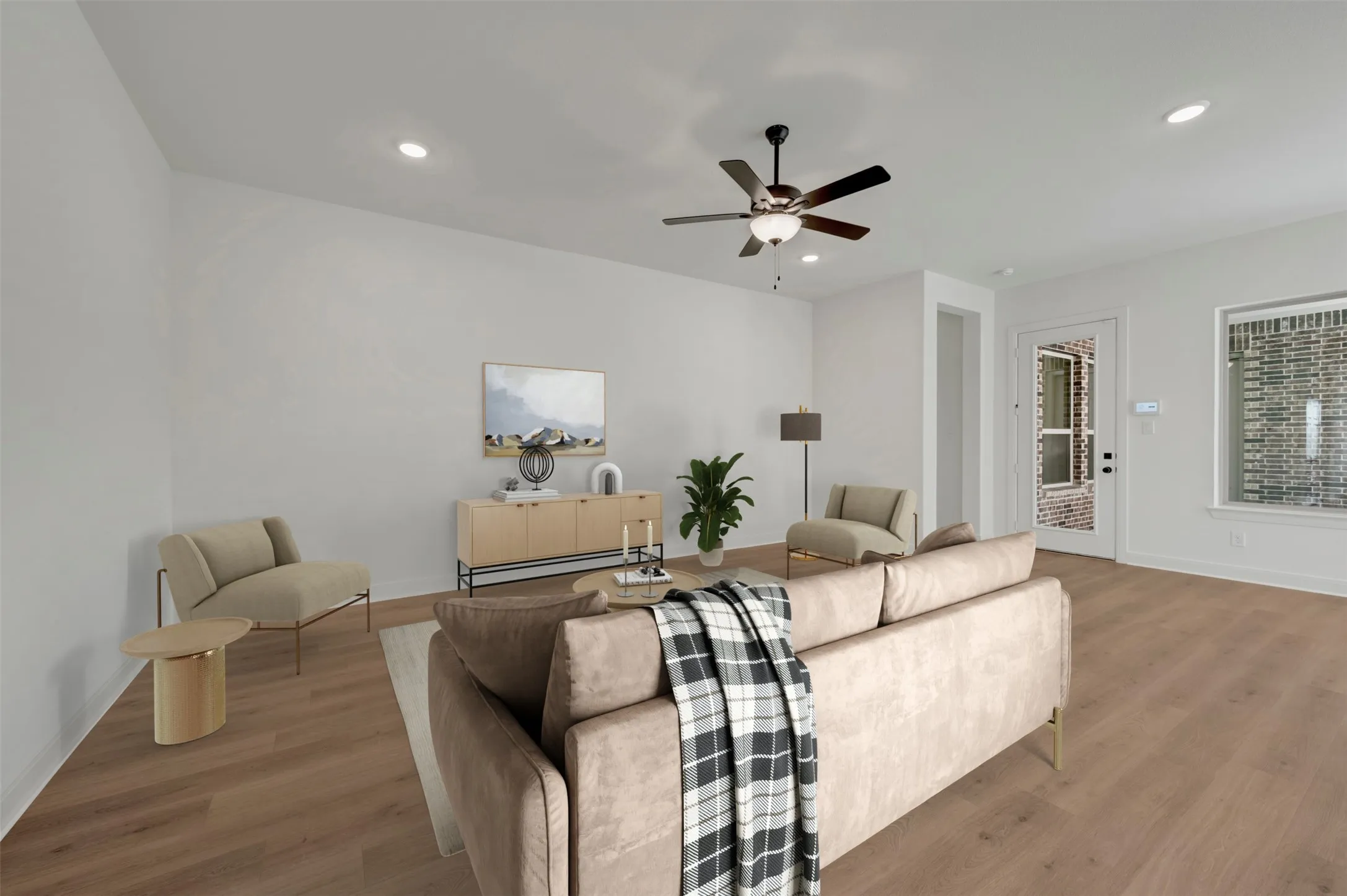 Spacious living area featuring wood-finish flooring, recessed lighting, and a ceiling fan