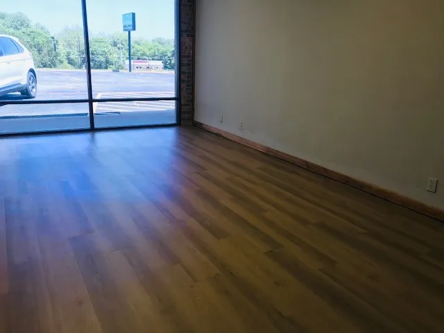 Empty room featuring dark wood-type flooring