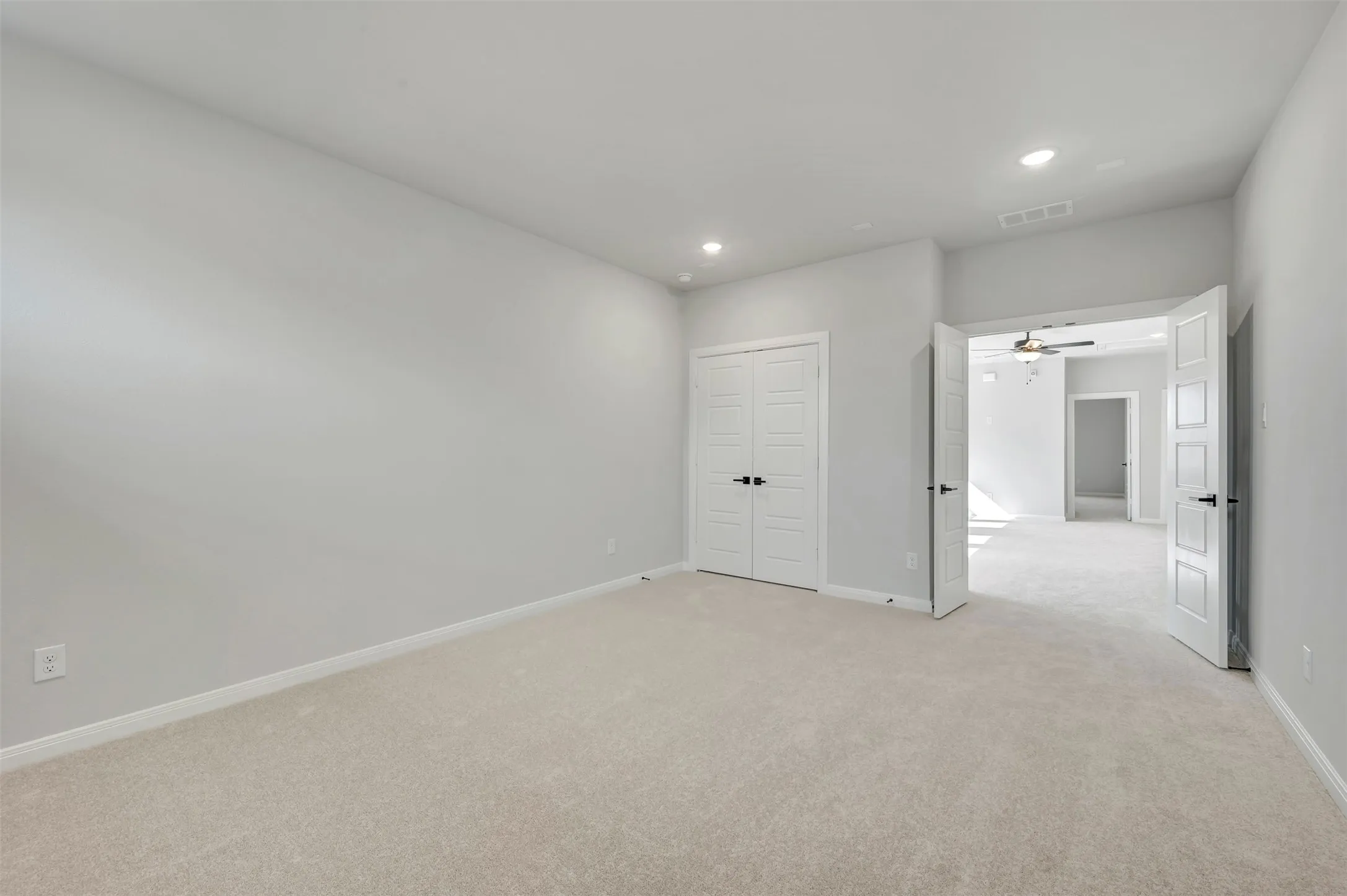 Unfurnished bedroom with light colored carpet, recessed lighting, and a closet