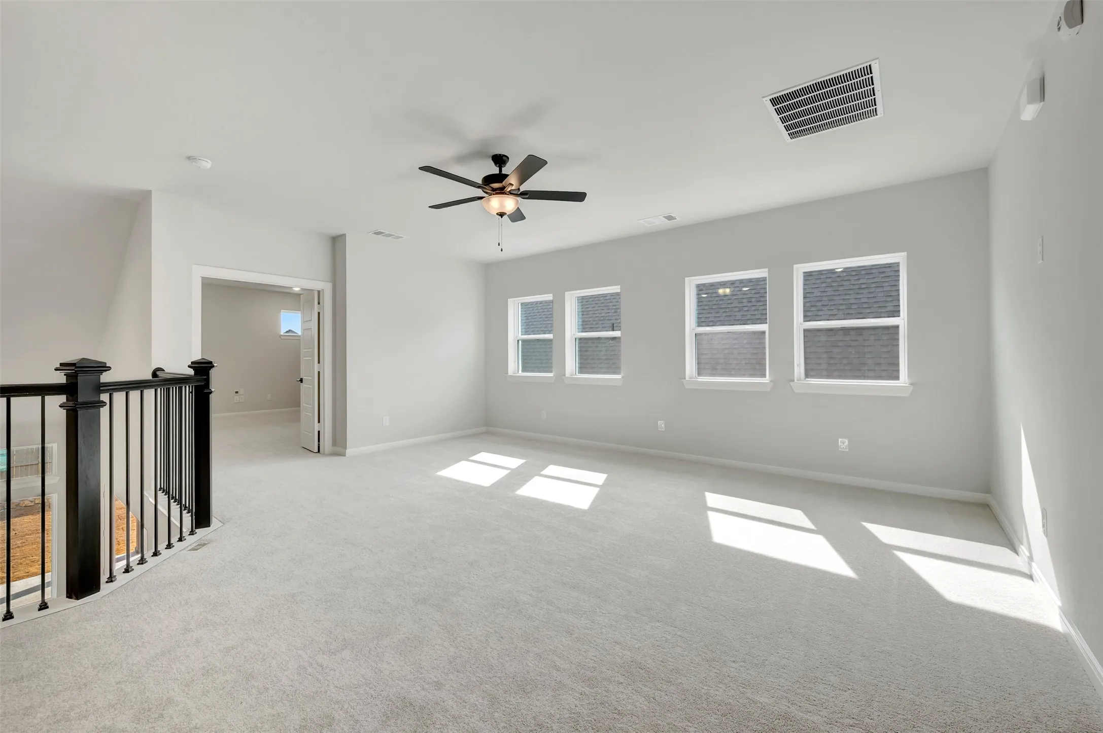 Spare room with carpet floors and ceiling fan
