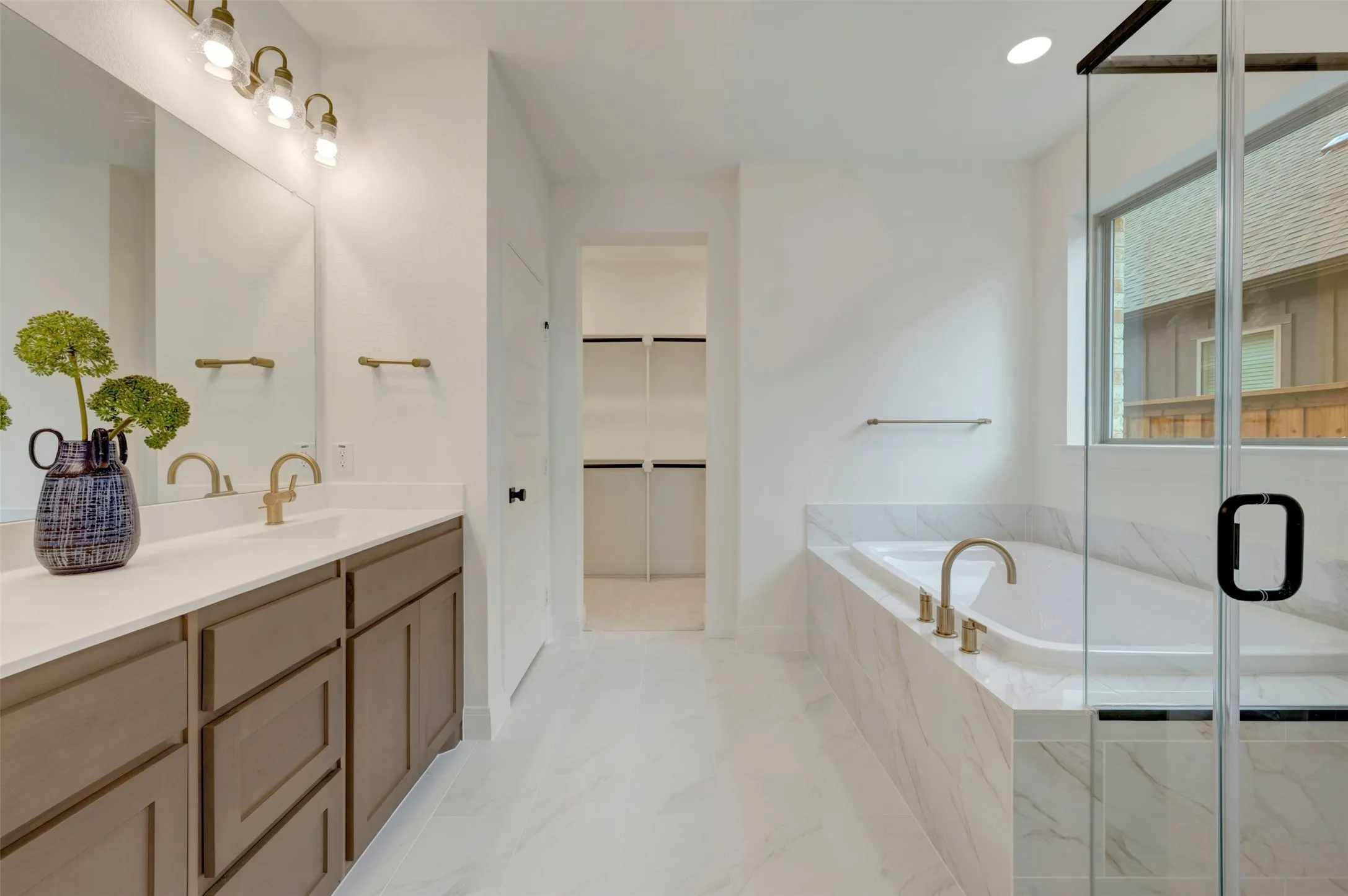 Dual vanity with light wood-finish cabinetry and white countertops