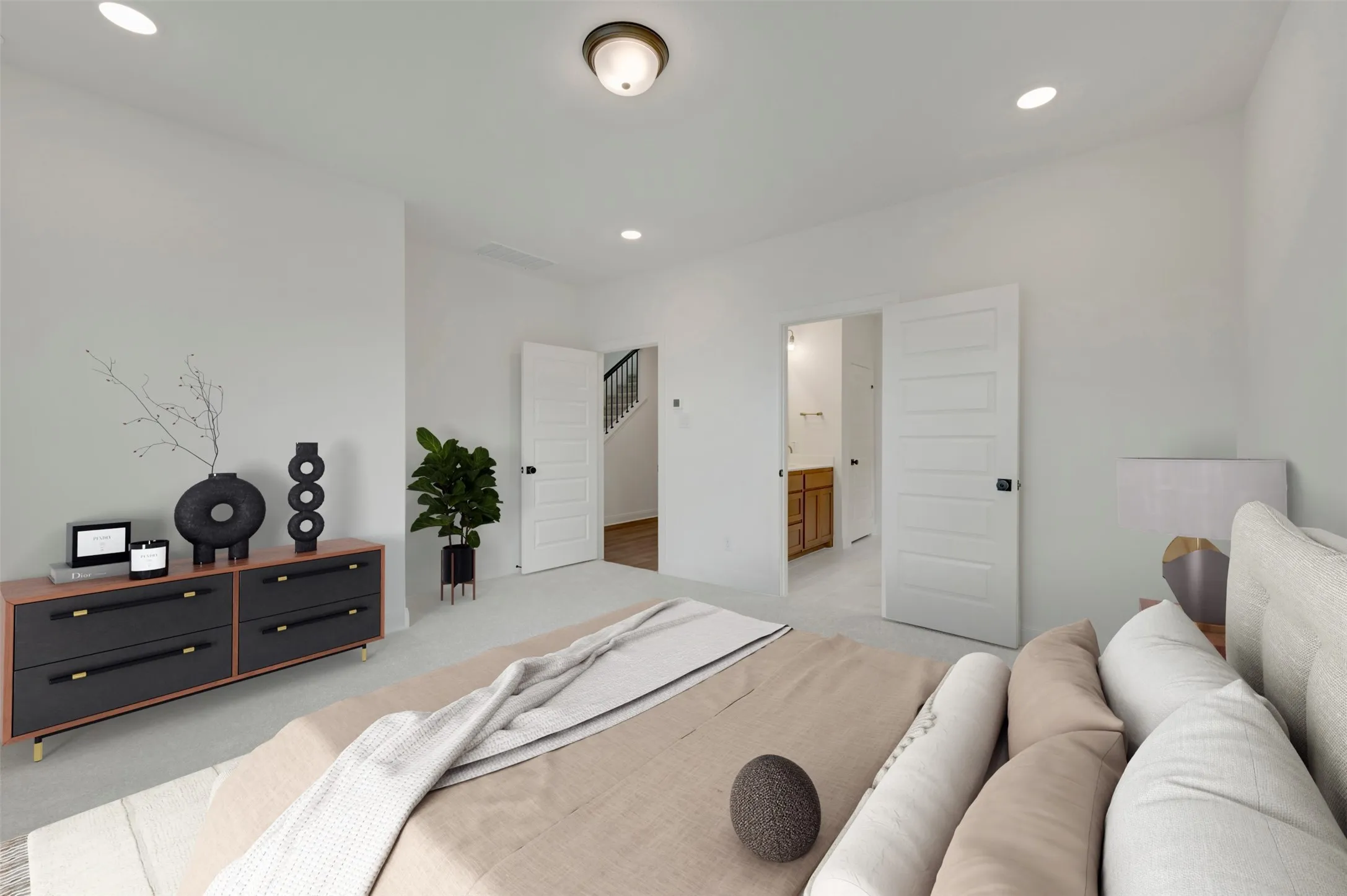 Carpeted interior space with recessed lighting, white paneled doors, and an adjacent staircase