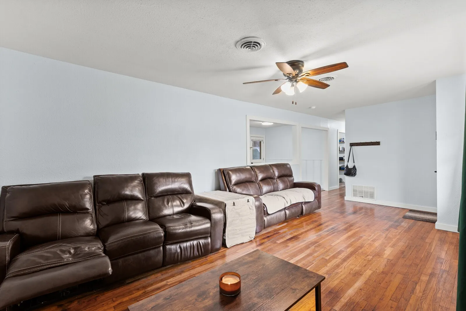Living area featuring hardwood / wood-style floors and a ceiling fan