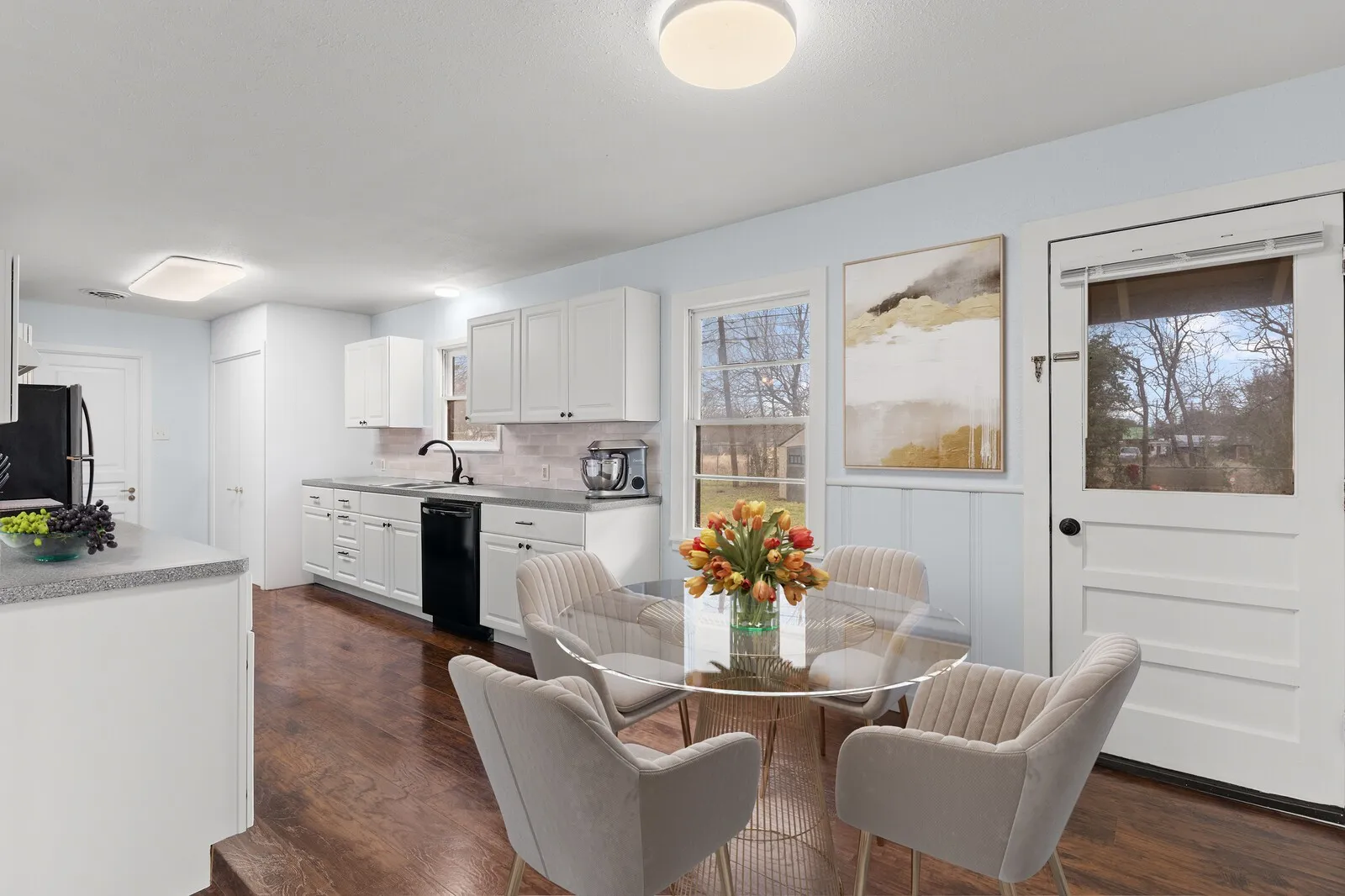 Dining room with dark wood-style flooring(virtual photo used to demonstrate spacing and room size.)