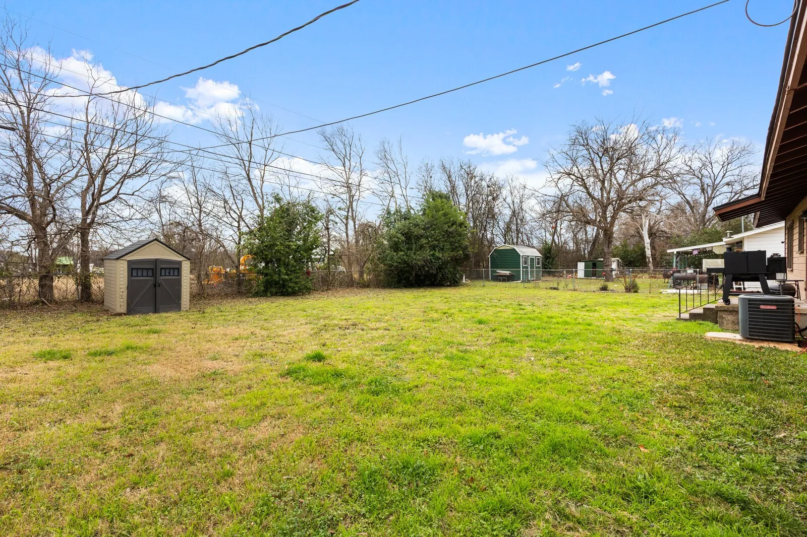 Fenced backyard featuring a shed and a patio