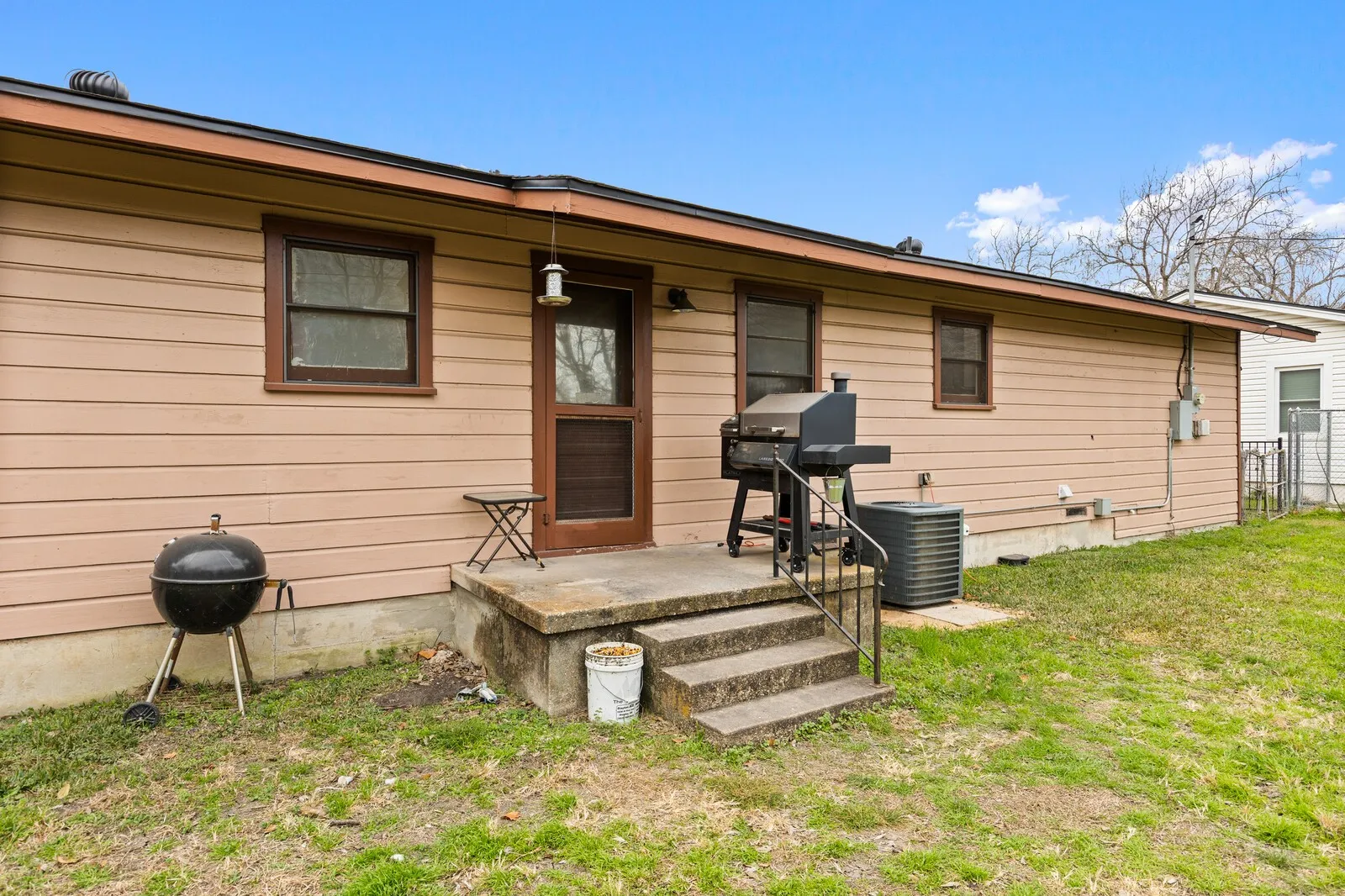 Back of property with a yard