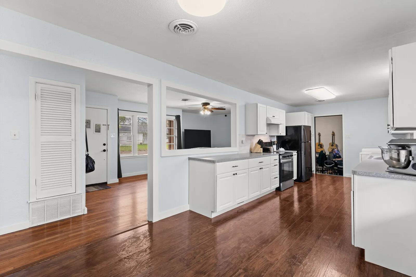 Kitchen with white cabinetry, stainless steel electric range oven, dark wood-style flooring, and a ceiling fan