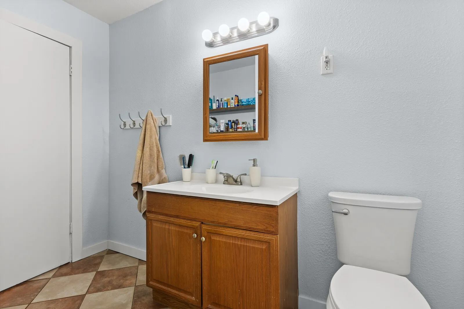 Half bathroom featuring vanity and toilet