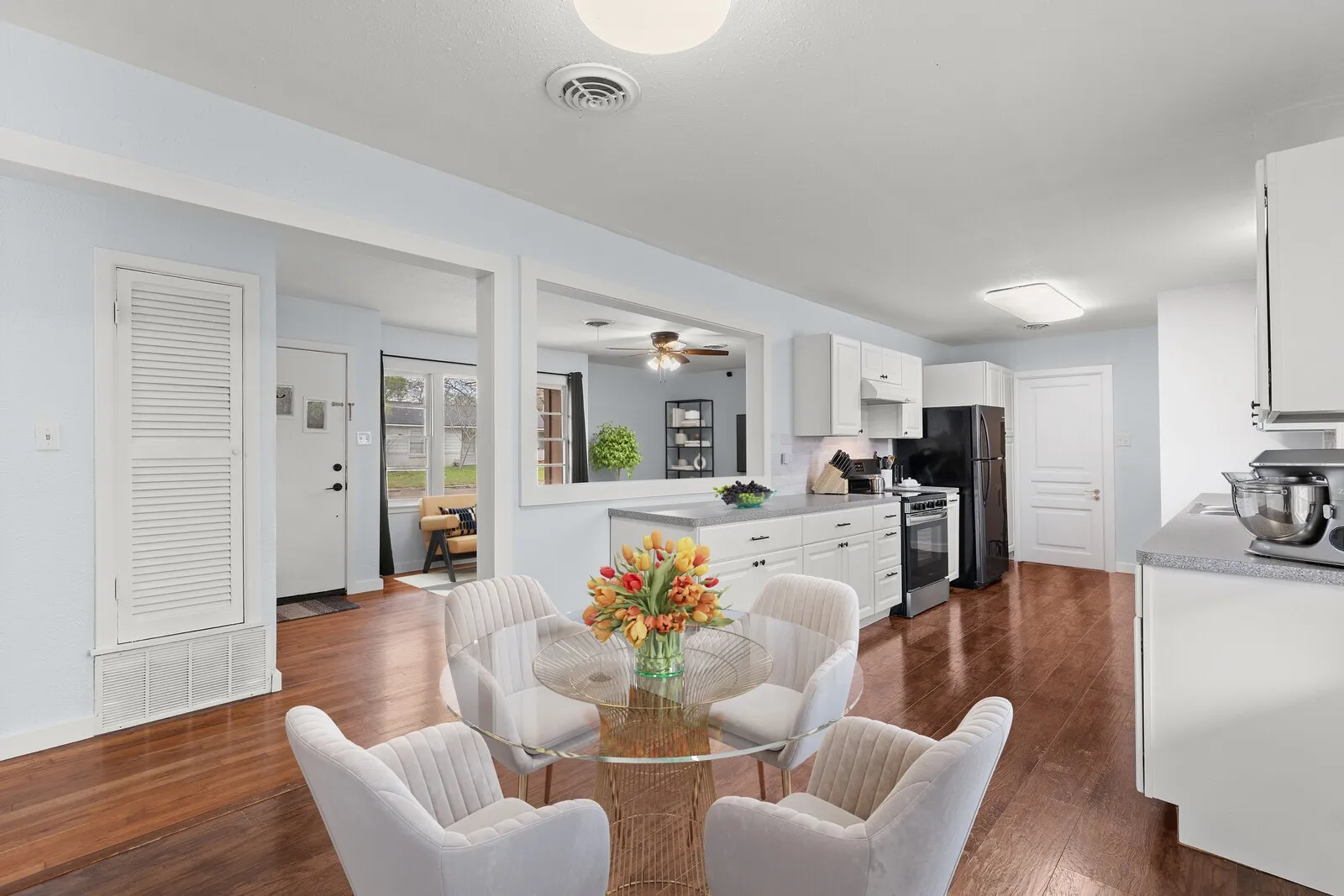 Dining area featuring dark wood-style floors and ceiling fan(virtual photo used to demonstrate spacing and room size.)