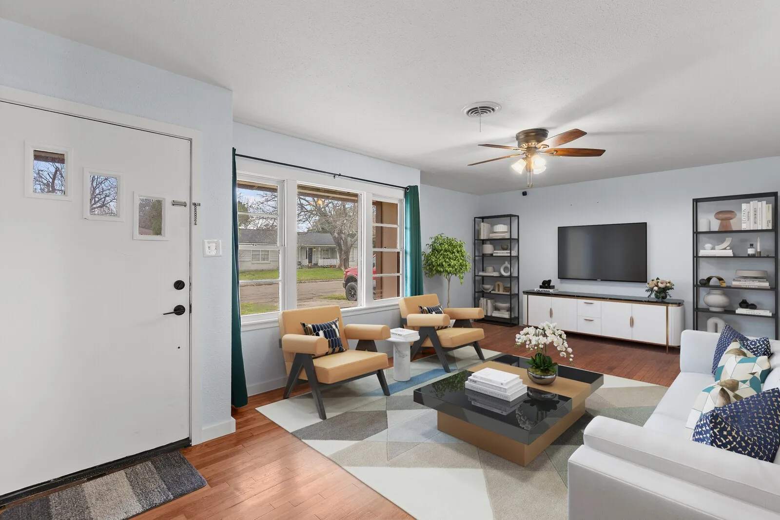 Living area featuring wood finished floors and a ceiling fan (virtual photo used to demonstrate spacing and room size.)