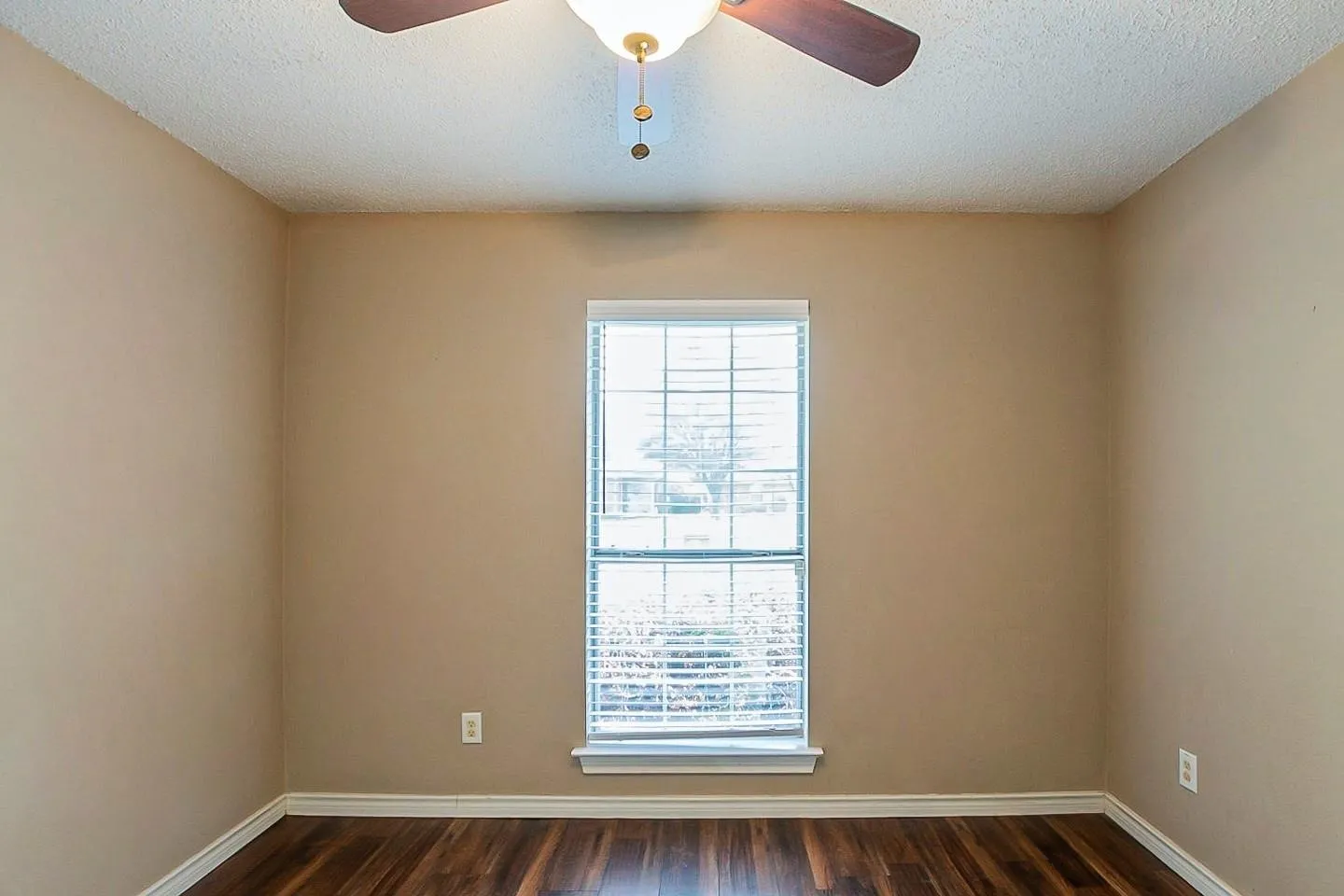 Unfurnished room with dark wood finished floors, a textured ceiling, and ceiling fan