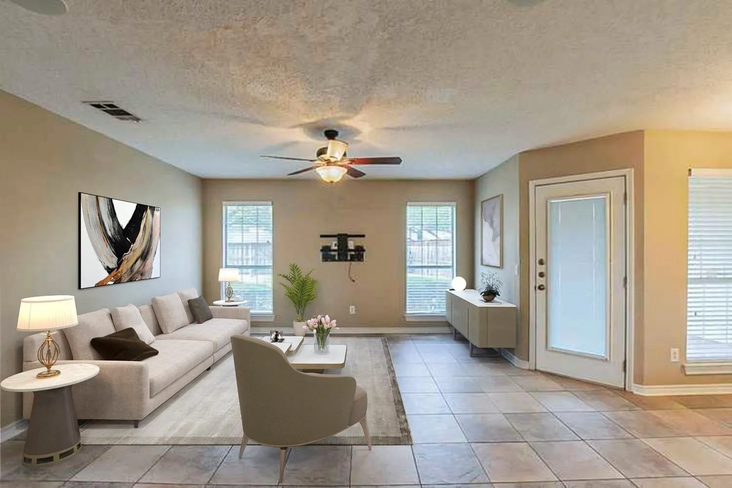 Living area with a textured ceiling, light tile patterned floors, and a ceiling fan
