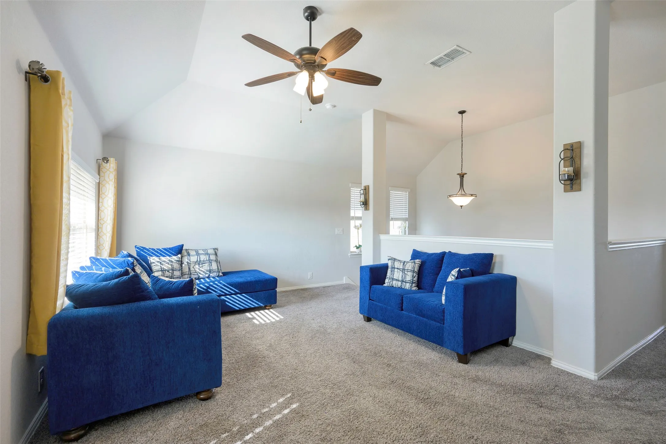 Upstairs Carpeted living room with lofted ceiling and a ceiling fan