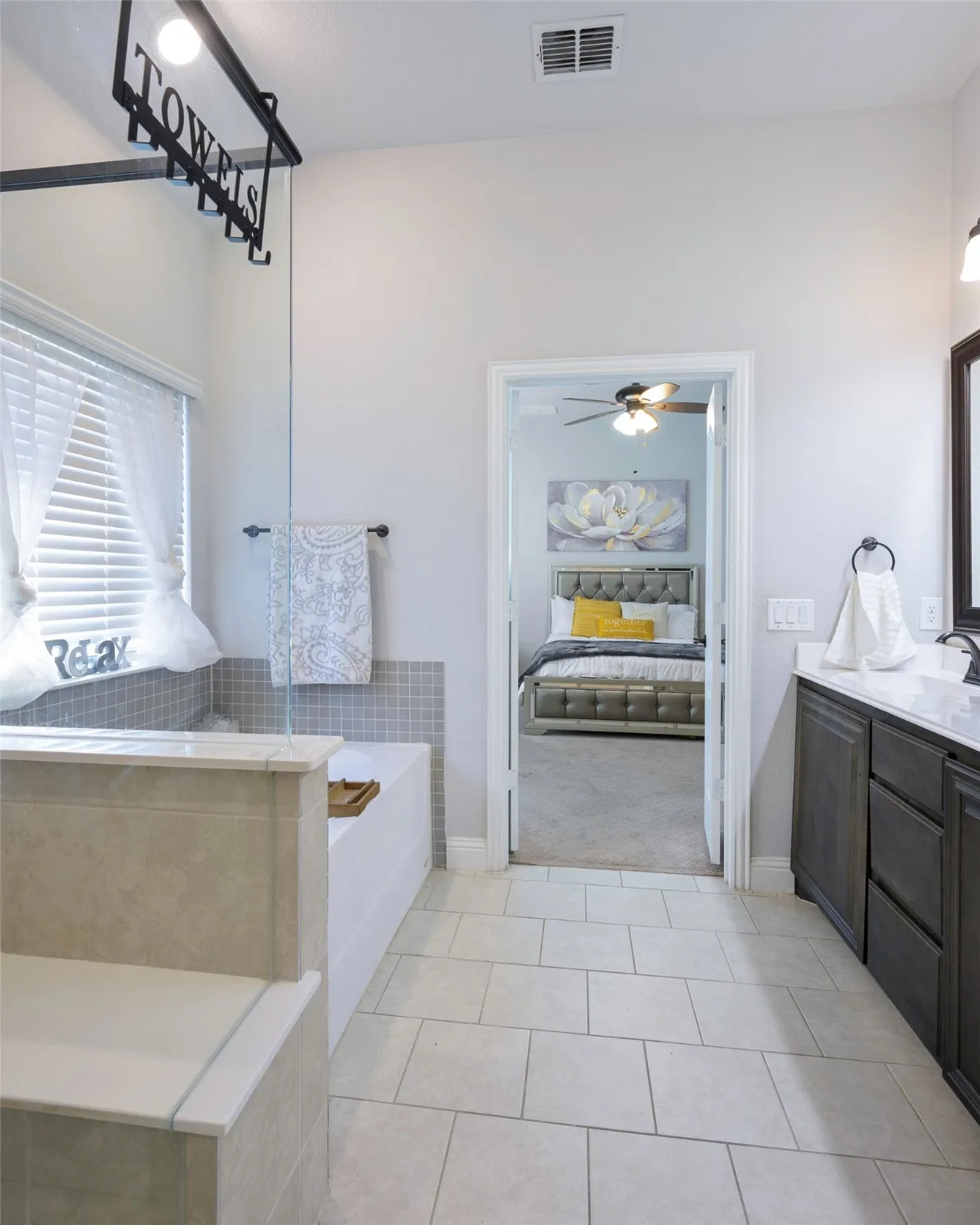 Ensuite bathroom with vanity, light tile patterned flooring, a bath, and ceiling fan