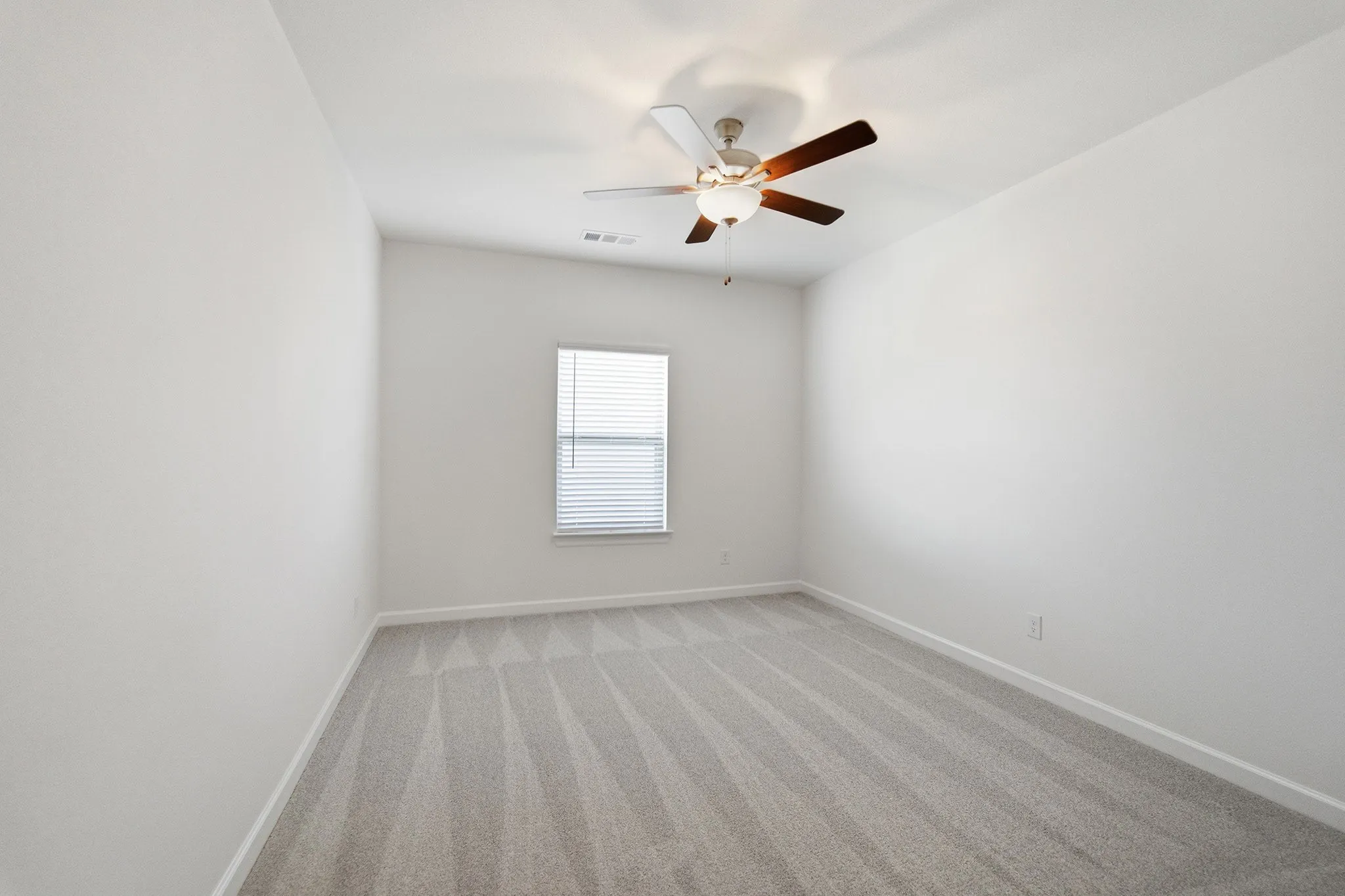 Room featuring light gray patterned carpeting and white painted walls