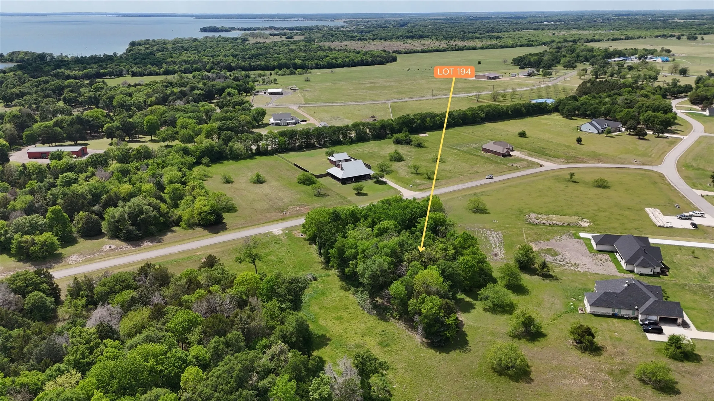 Elevated view showcases the wooded homesite and its desirable location near the expansive waters of Richland Chambers Lake.