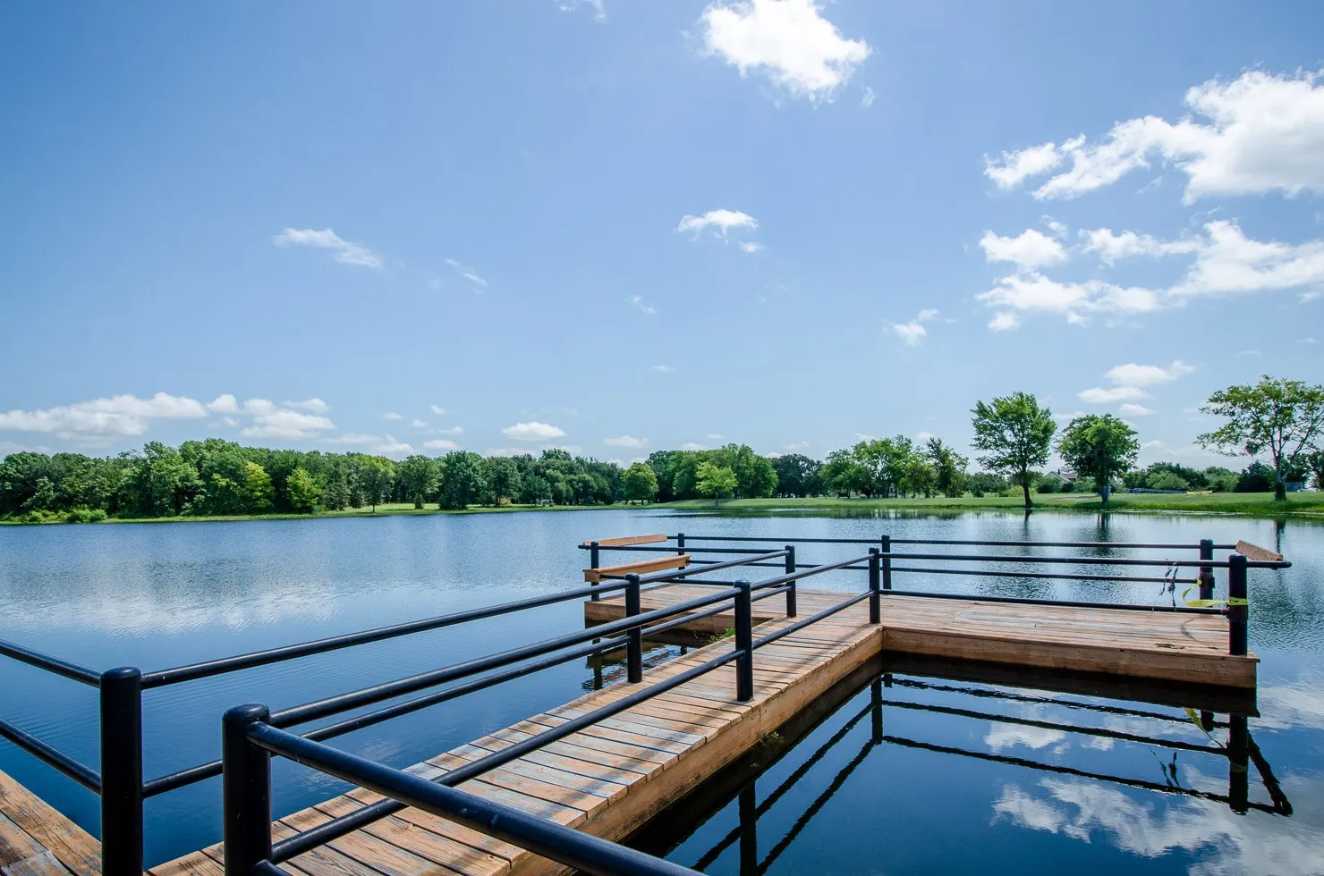 Community fishing pier offers a peaceful place to cast a line and enjoy the private stocked lake inside The Shores.