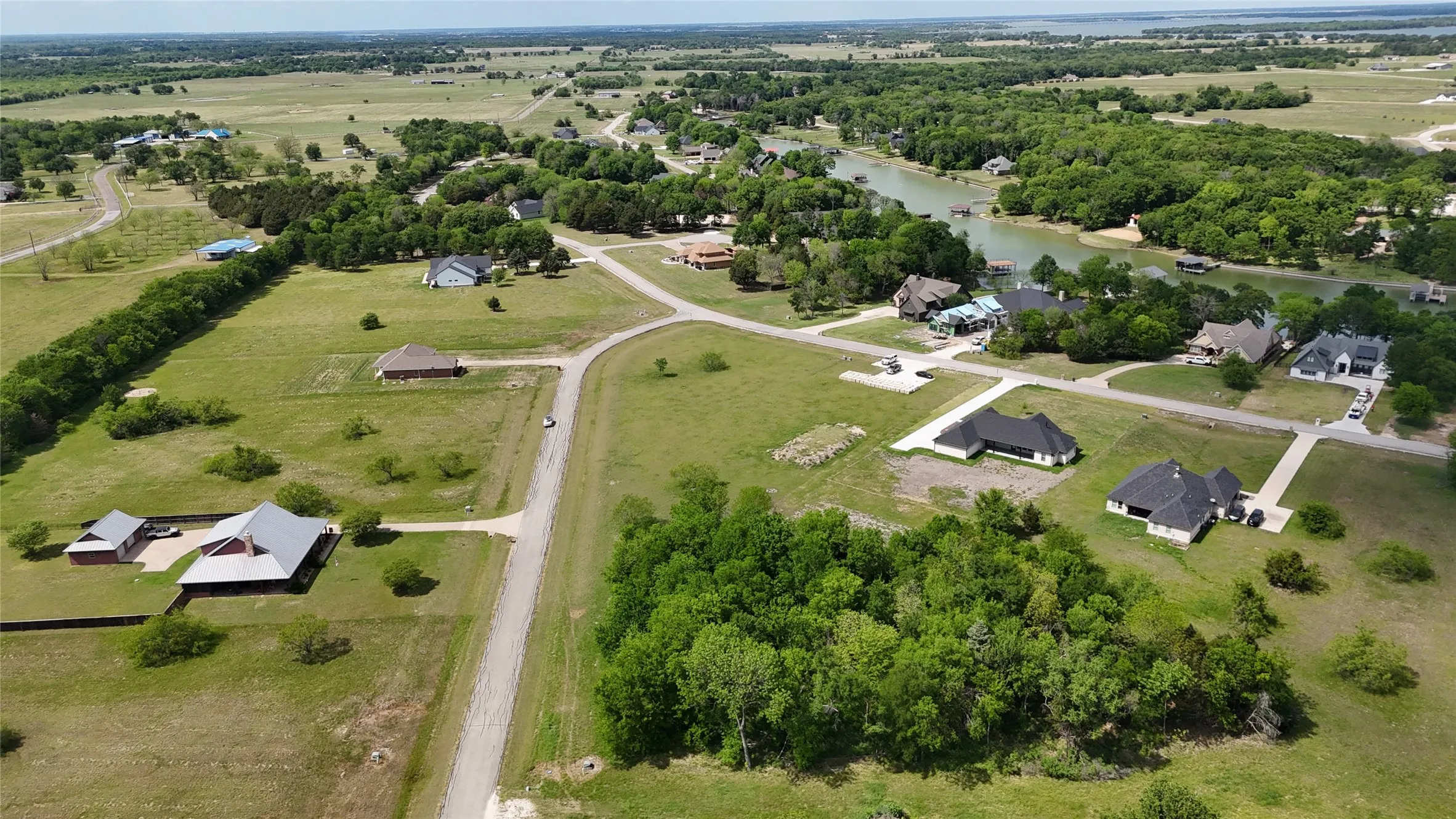 Lot 194 sits among established homes and spacious properties in The Shores, offering a wooded setting for building in Central Texas.