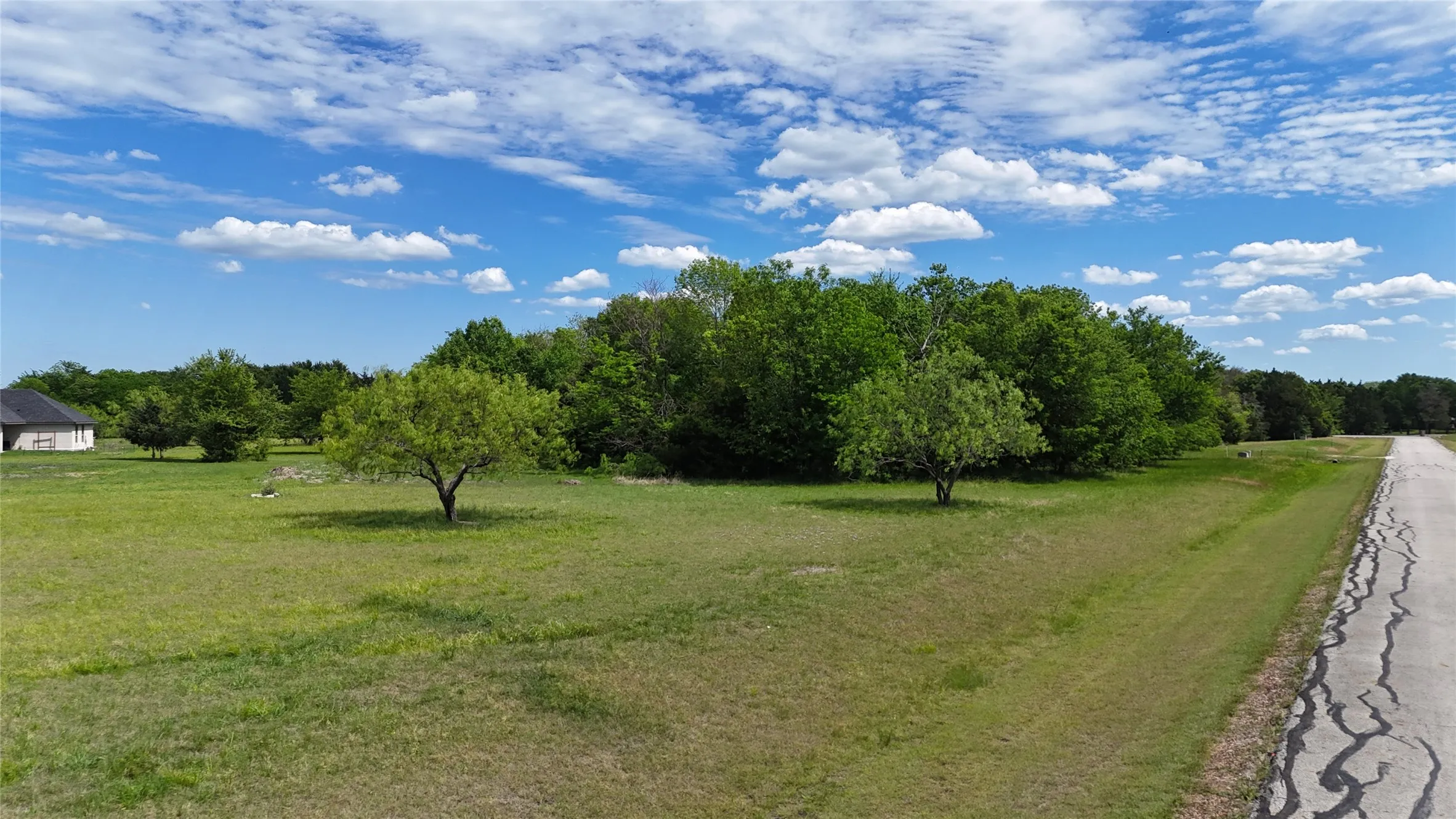 Mature tree coverage gives Lot 194 a secluded feel while keeping the property close to lake recreation and community amenities.
