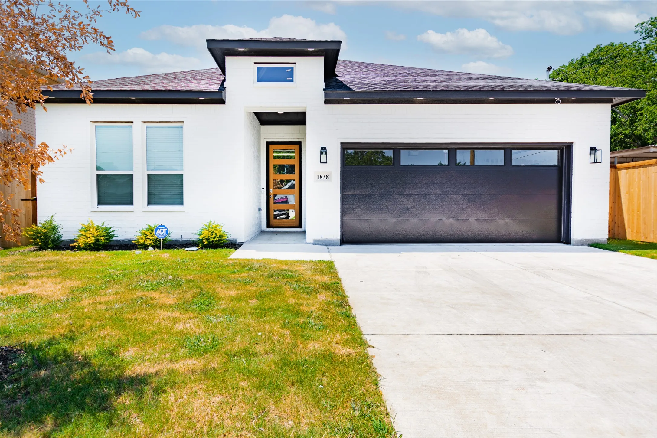View of front of home with a front yard and a garage