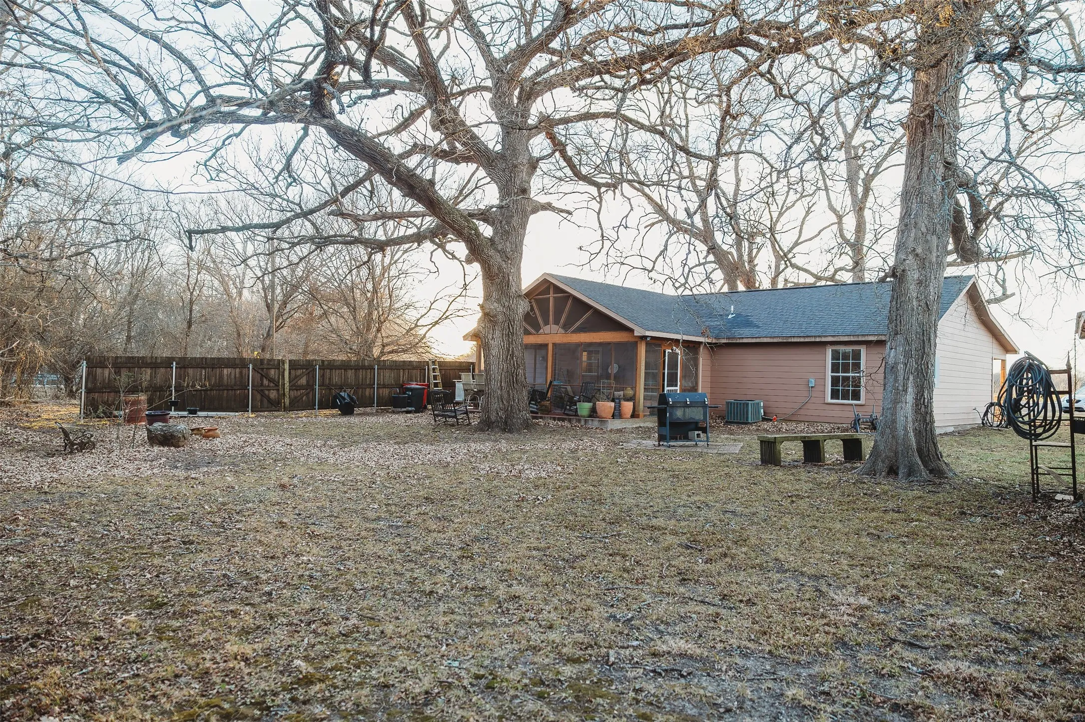 Back of house featuring a patio and a sunroom