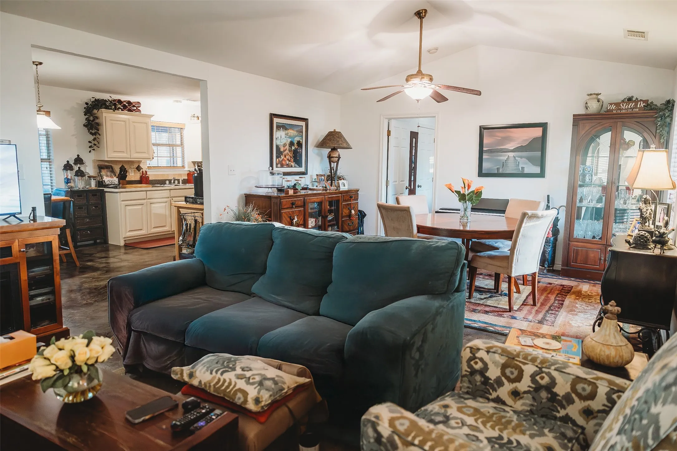 Living area featuring lofted ceiling and a ceiling fan