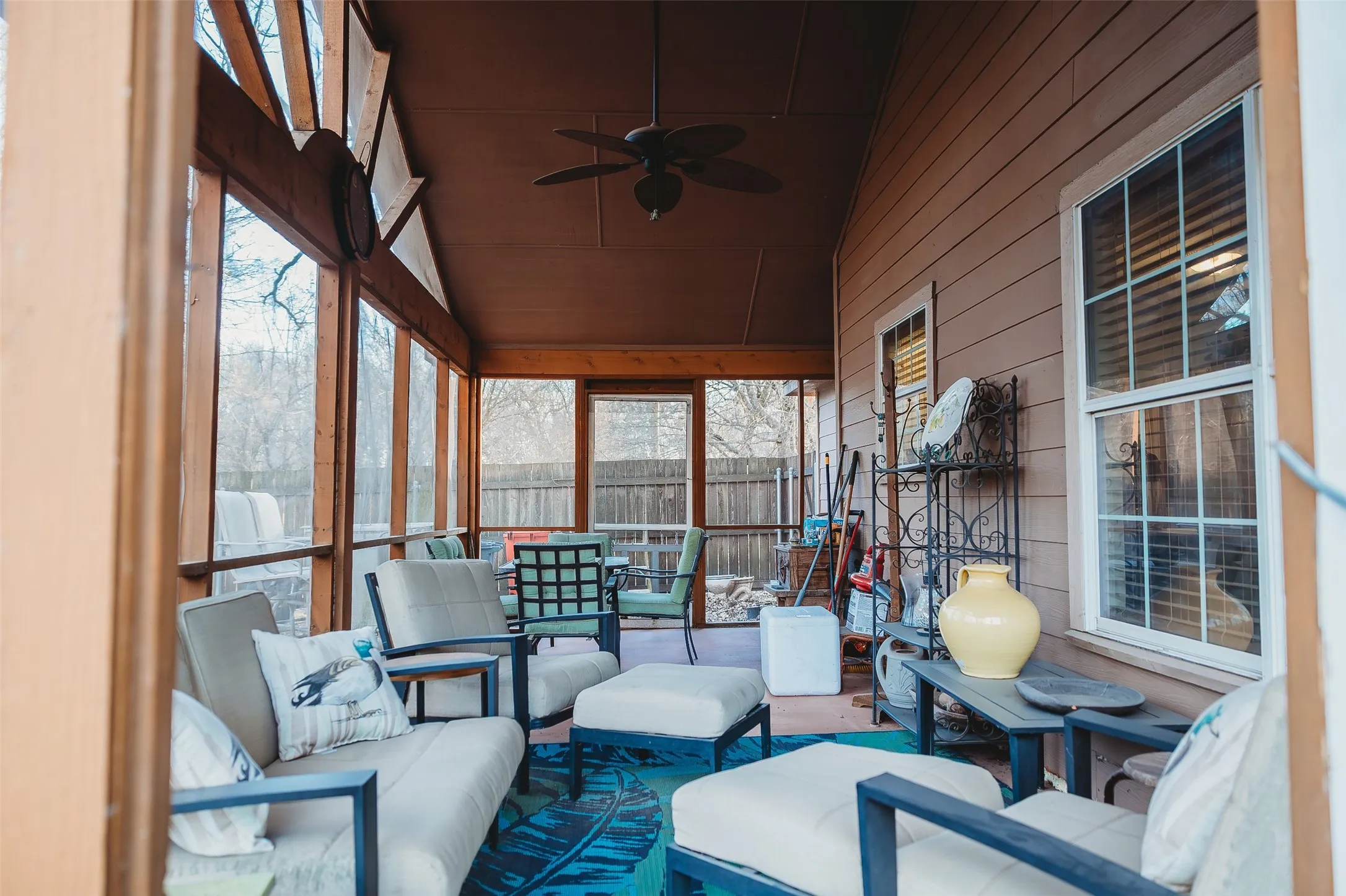 Sunroom featuring ceiling fan, an outdoor living space, and lofted ceiling