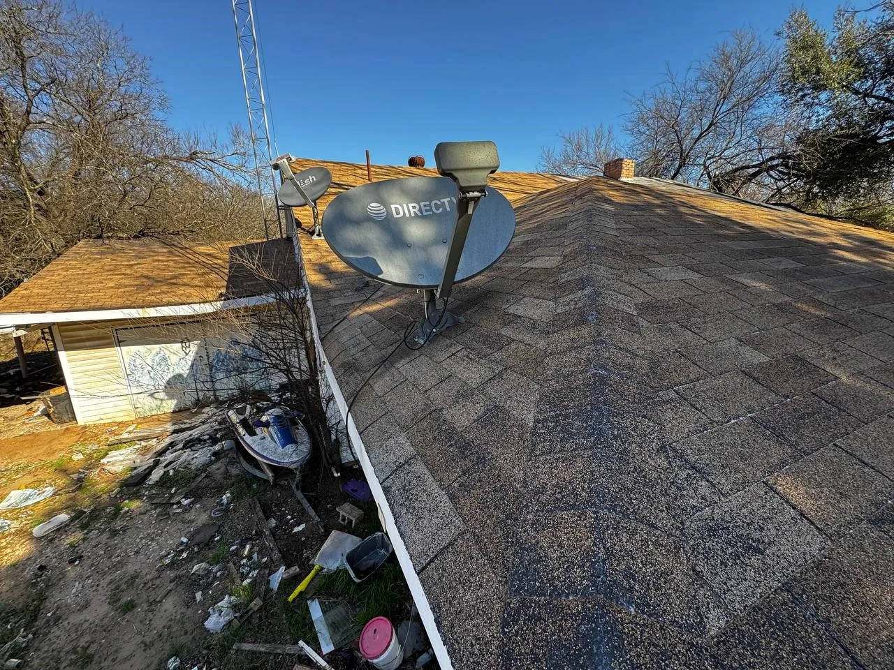 Exterior view of roof with shingles and a chimney