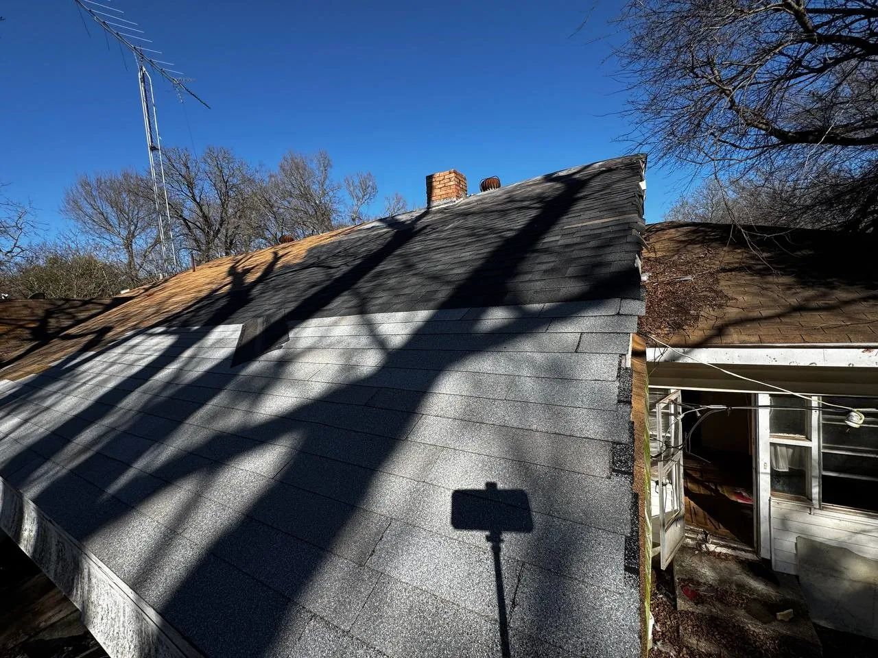 Exterior view of a shingled roof and a chimney