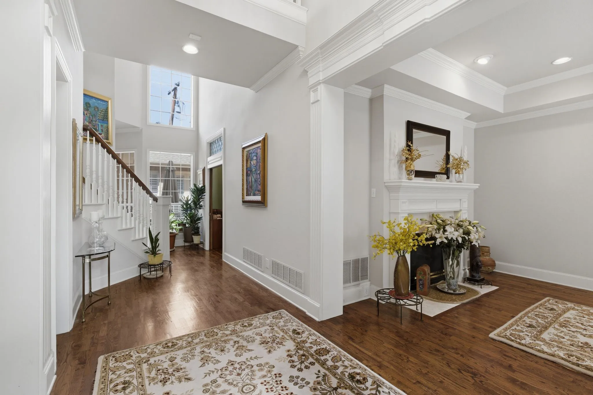 Foyer Open Light and bright with dark wood floors, crown molding