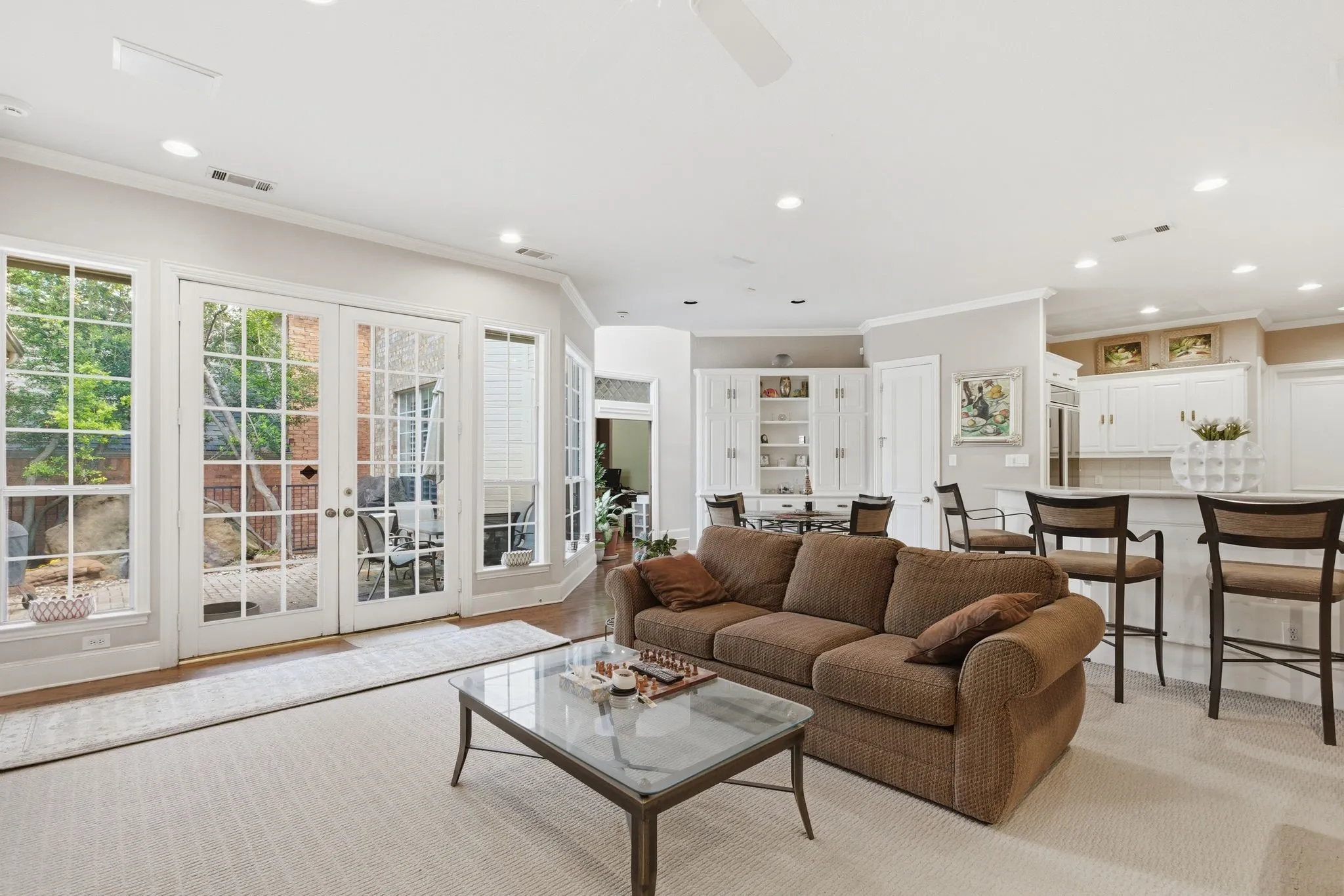 Living area with recessed lighting, ornamental molding, and french doors
