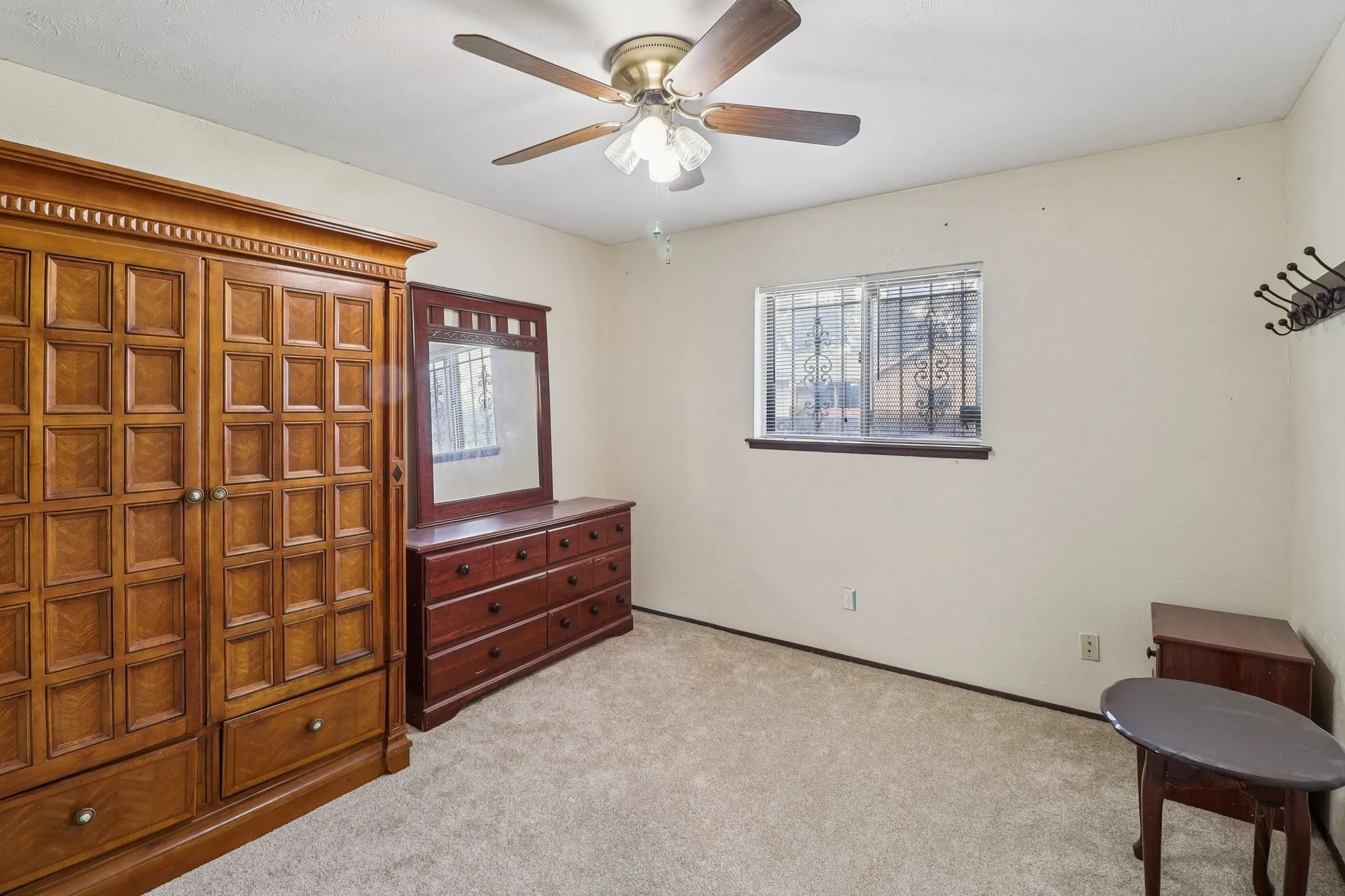 One of the bedrooms.   Carpet replaced 2025.  Ceiling fan and closet.