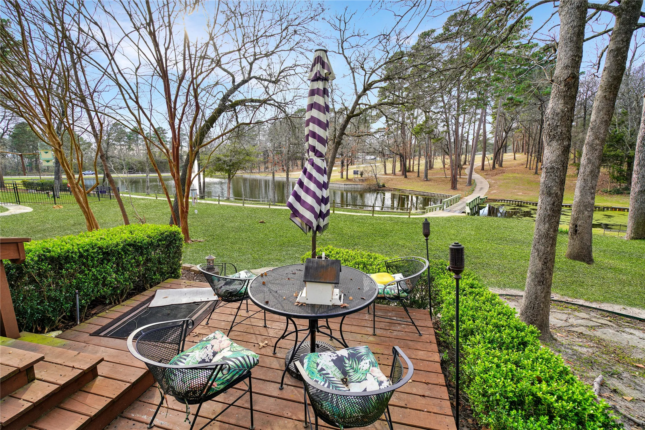 Wooden terrace featuring a water view and outdoor dining area