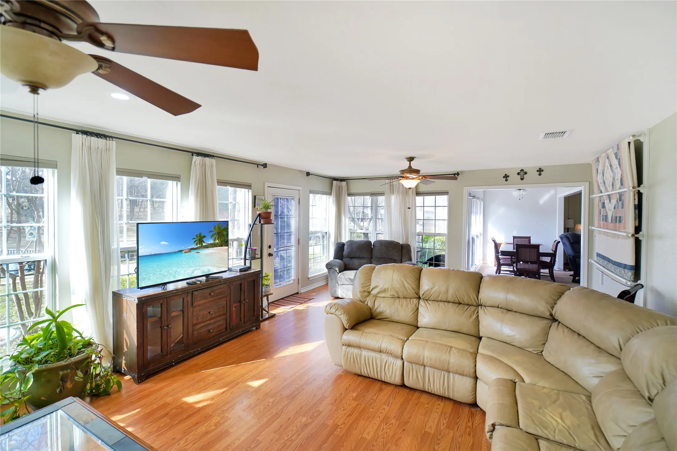 Living area featuring wood finished floors and ceiling fan