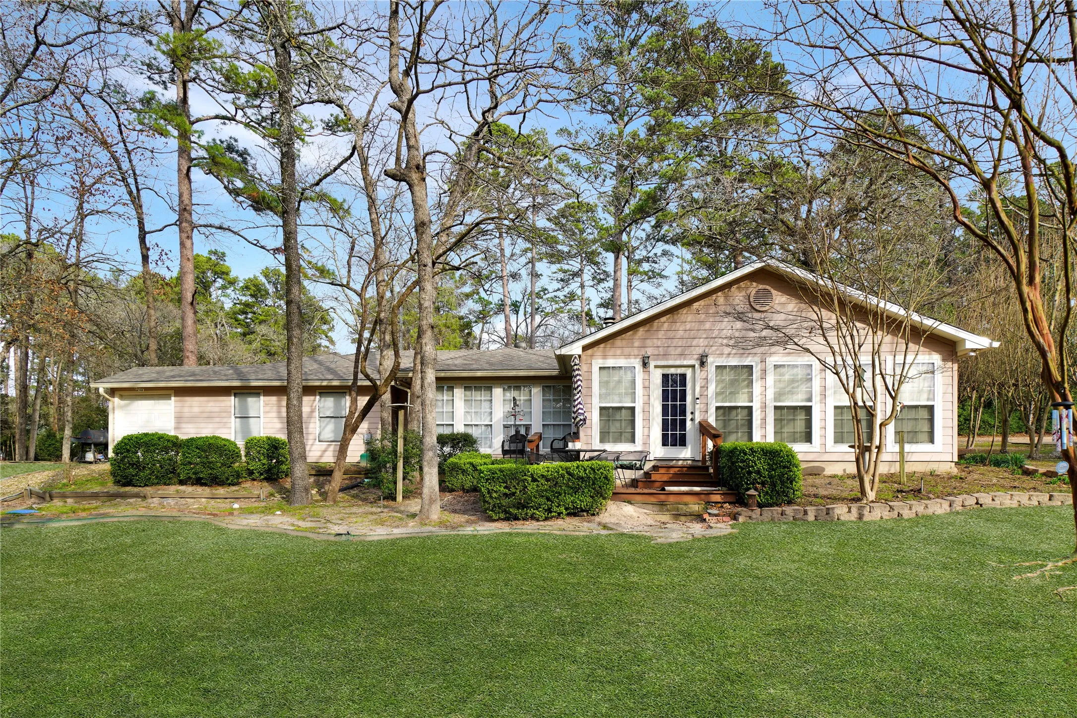 Ranch-style home featuring a front lawn