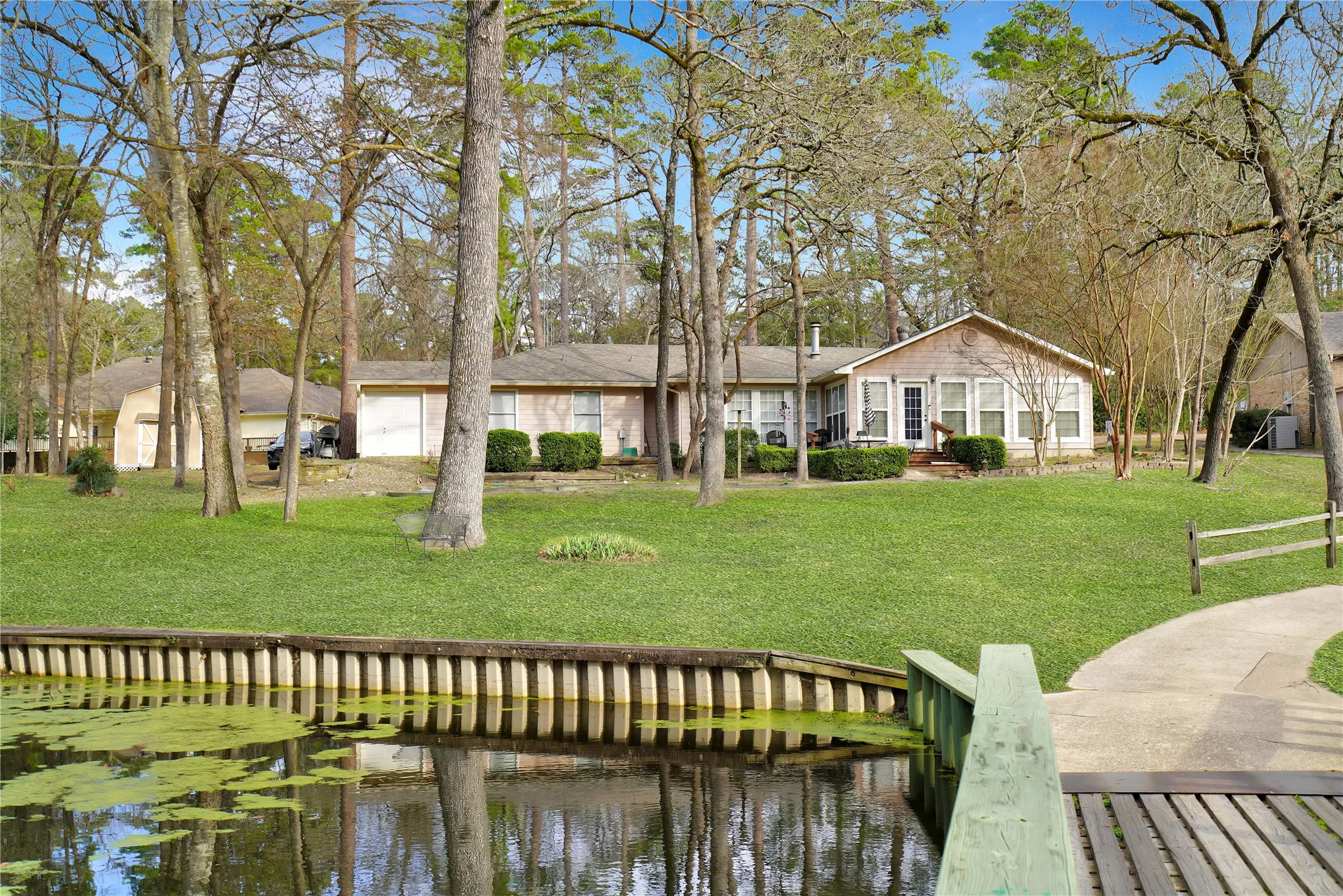 Dock area with a water view and a yard