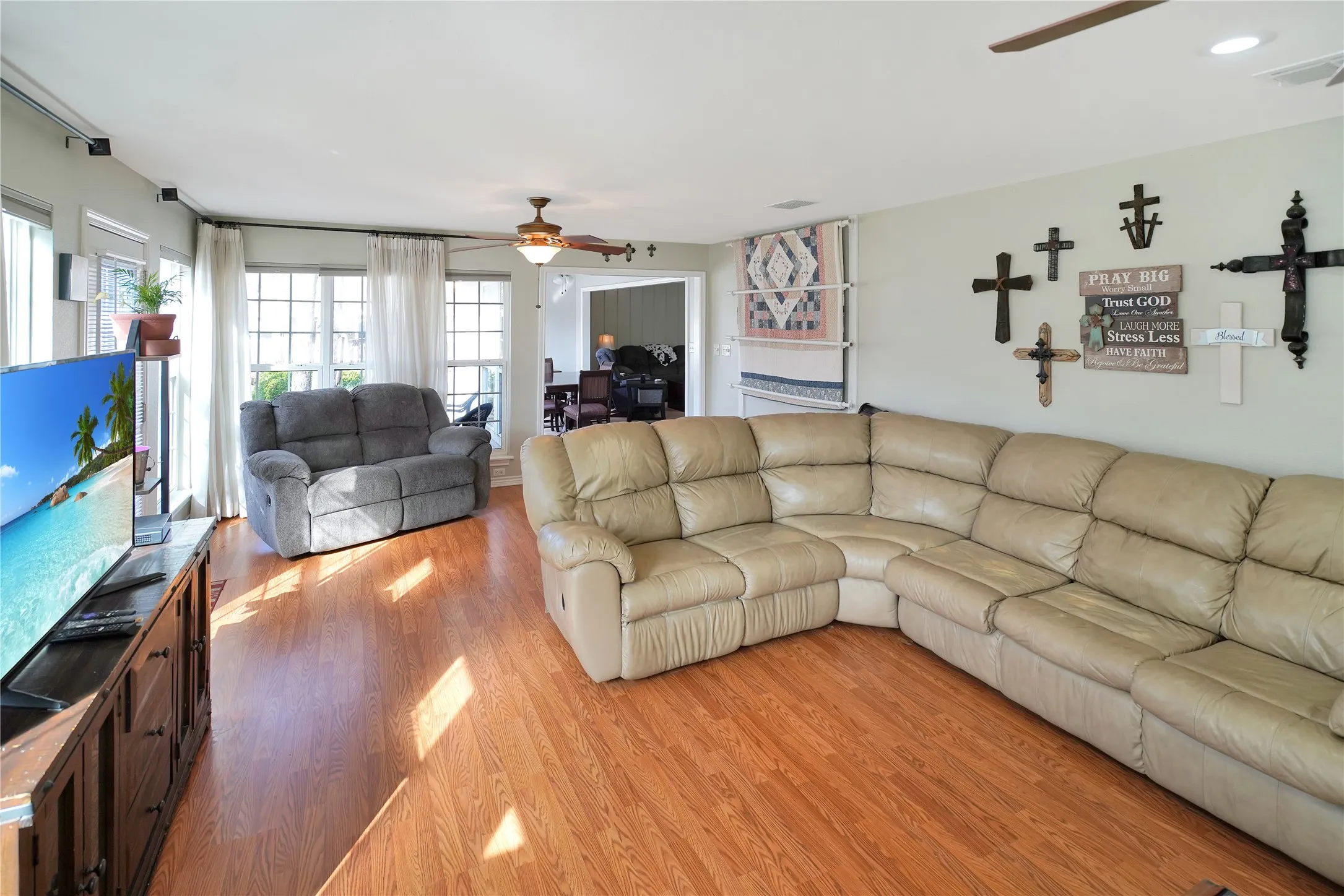 Living room featuring ceiling fan and wood finished floors