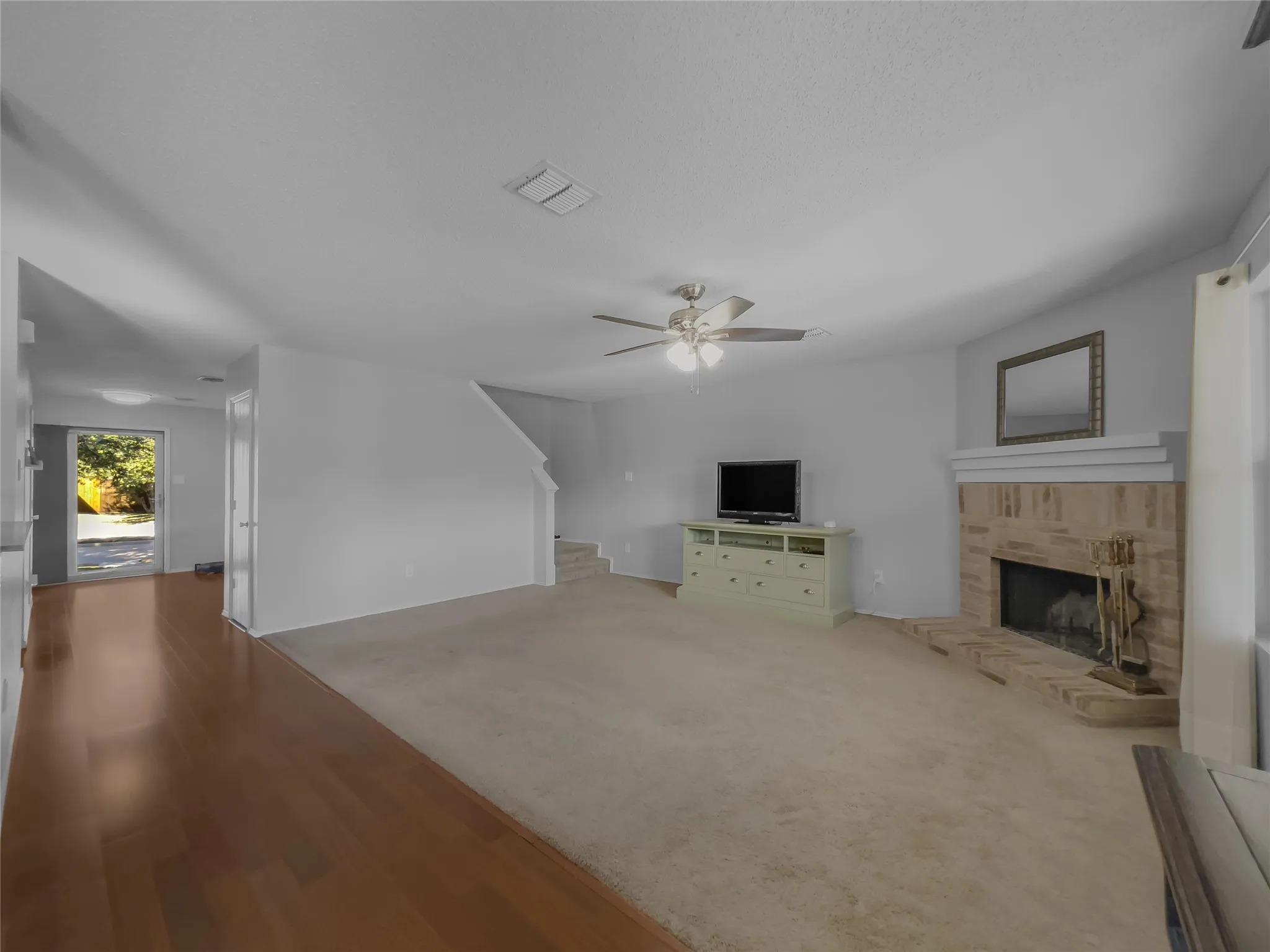 View of downstairs living room and fireplace