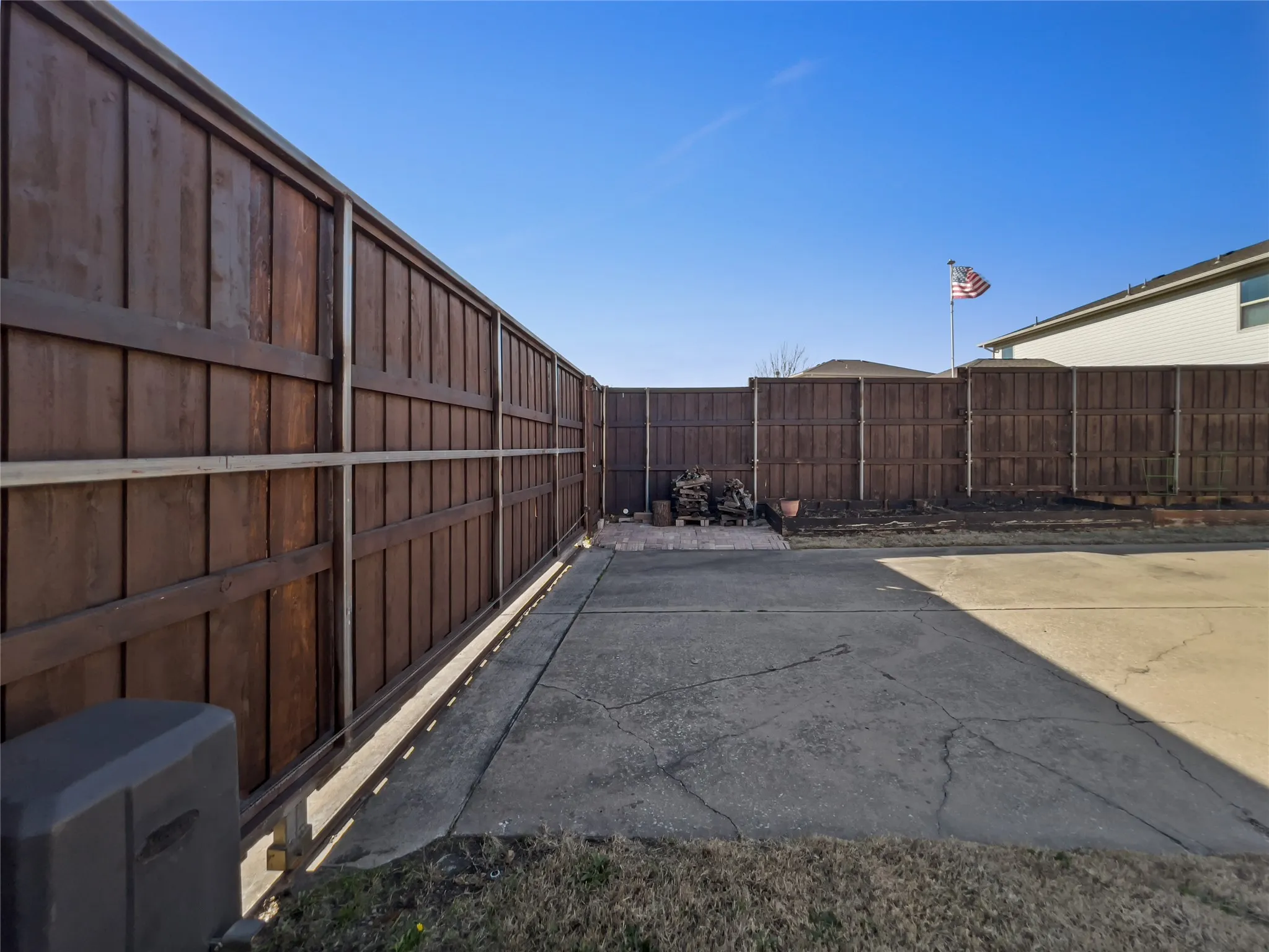 View of automatic board-on-board gate in backyard