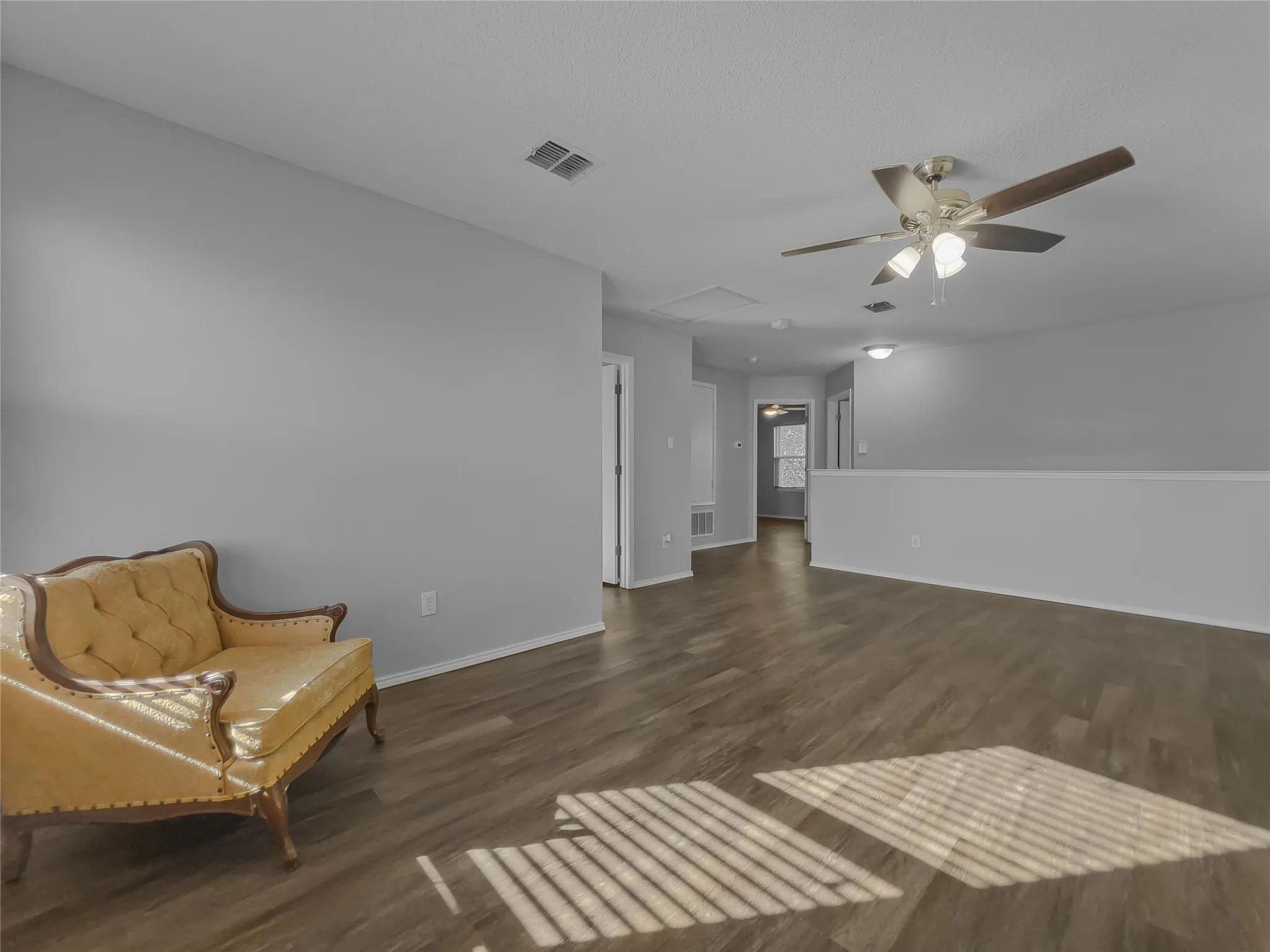 Upstairs living room with view toward stairs and 3rd bedroom