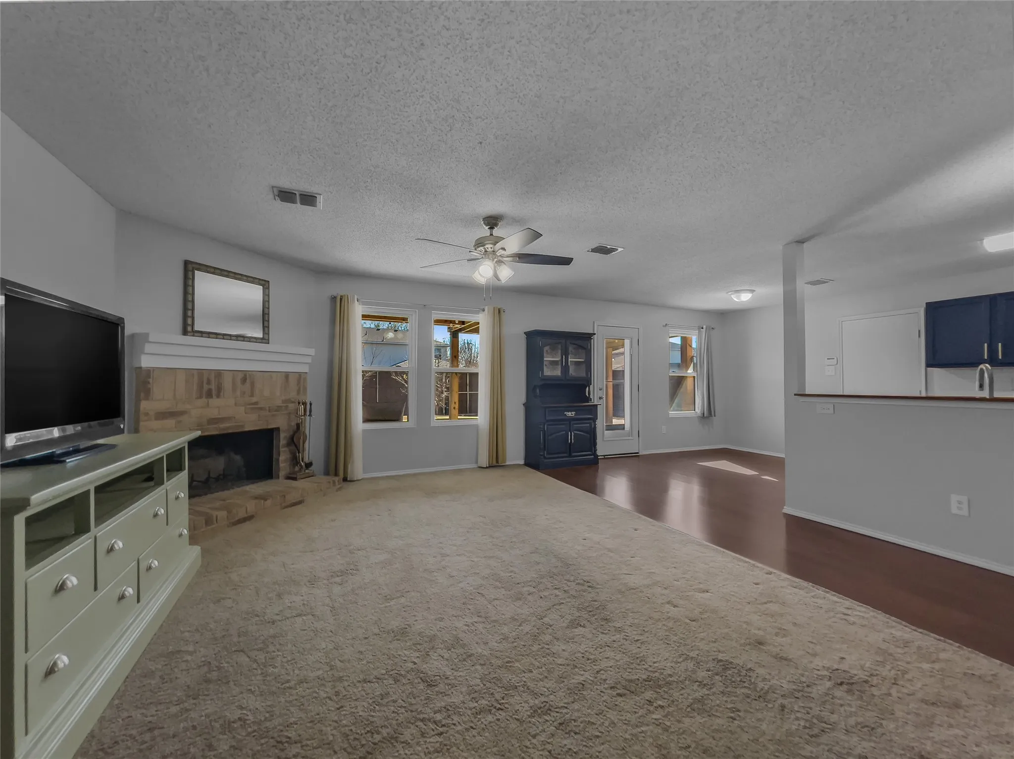 View of downstairs living room into kitchen area