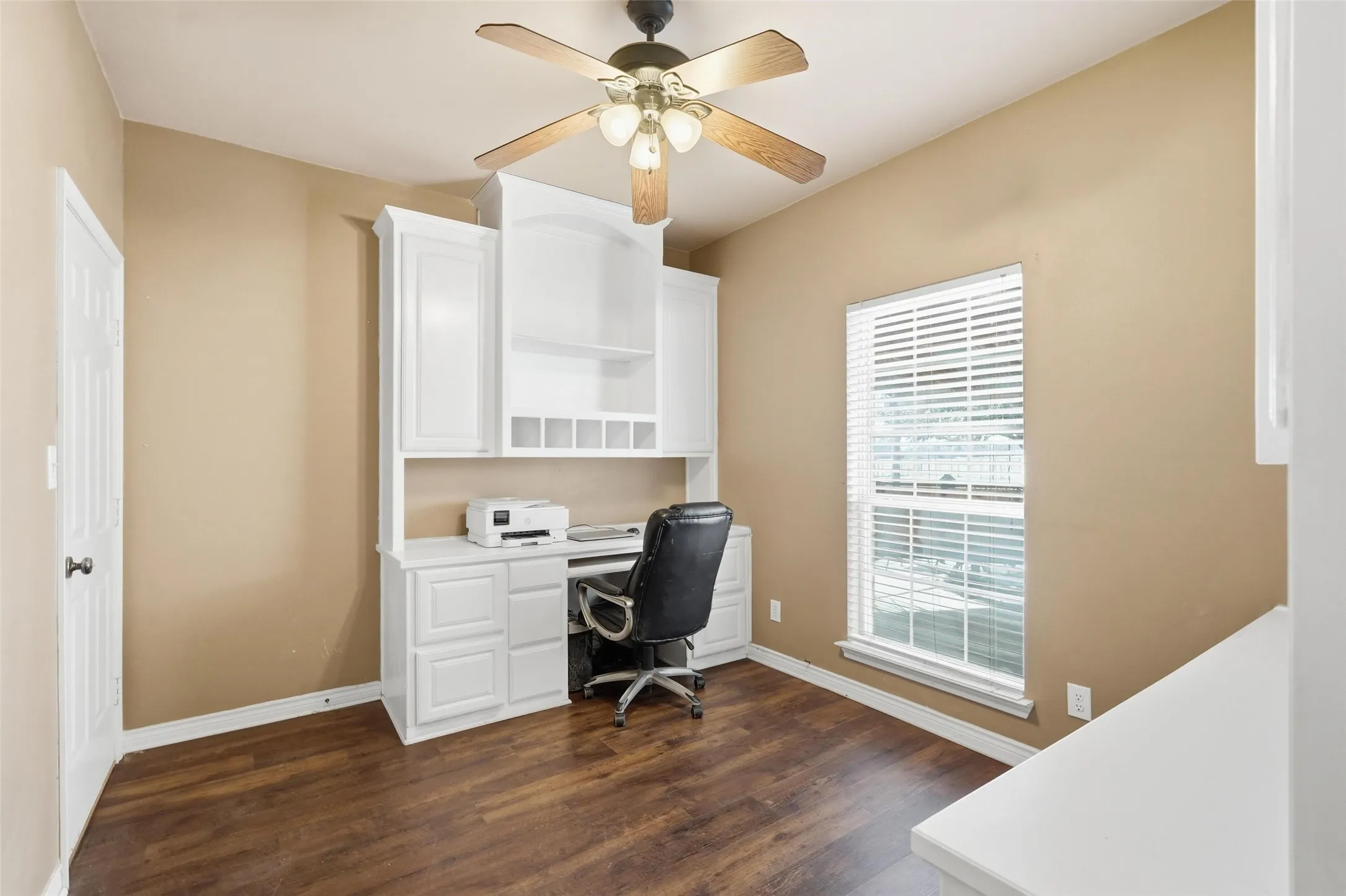 Office adjacent to primary bedroom with exterior door.