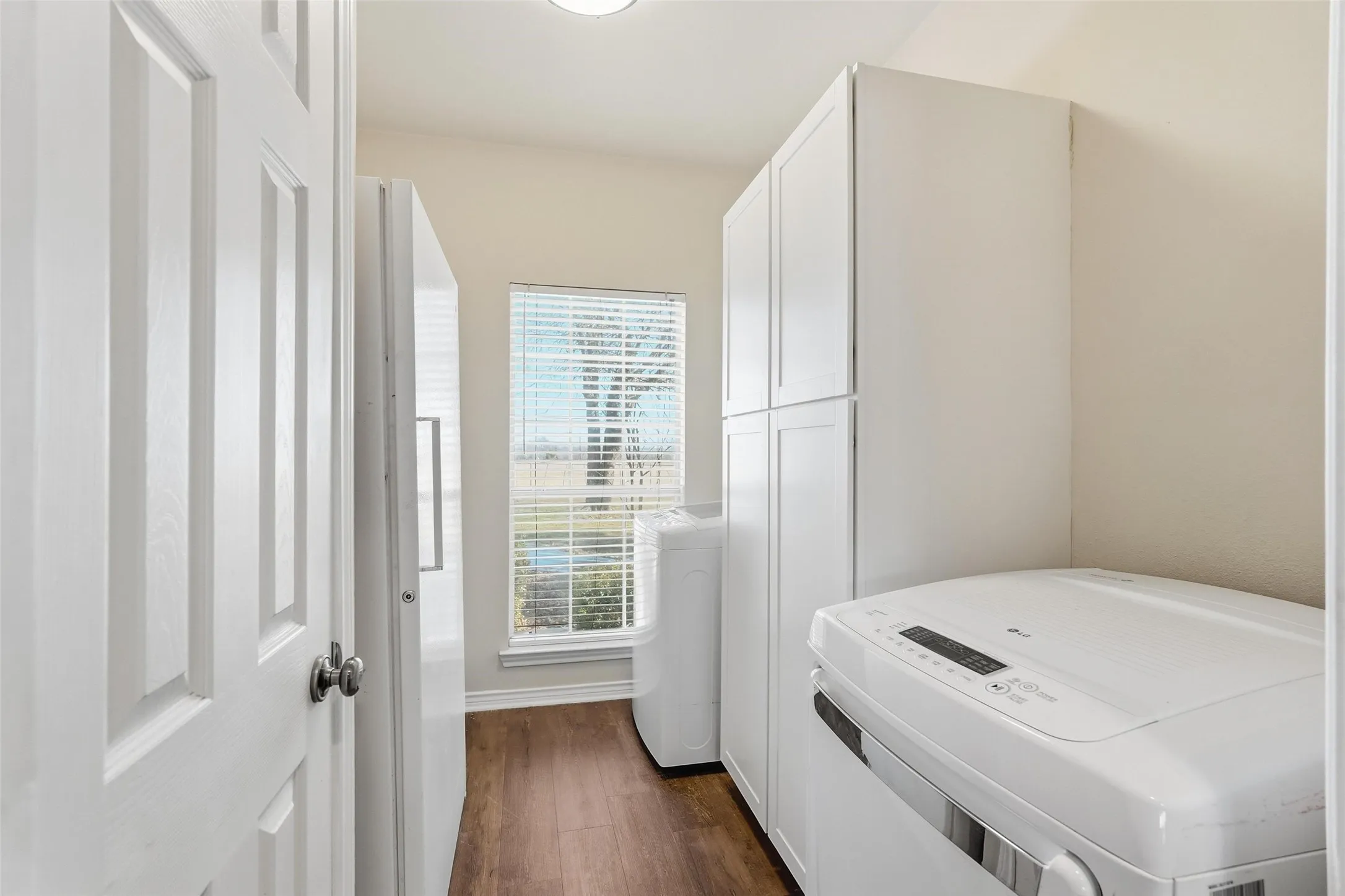 Large laundry room also accommodates freezer and extra storage.