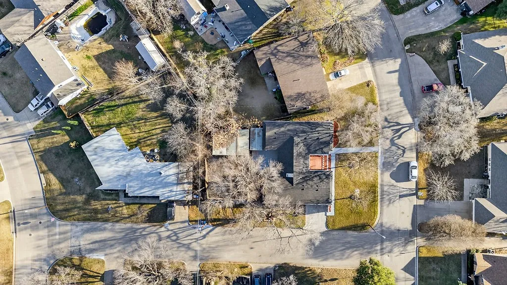 Aerial view of property's location with nearby suburban area