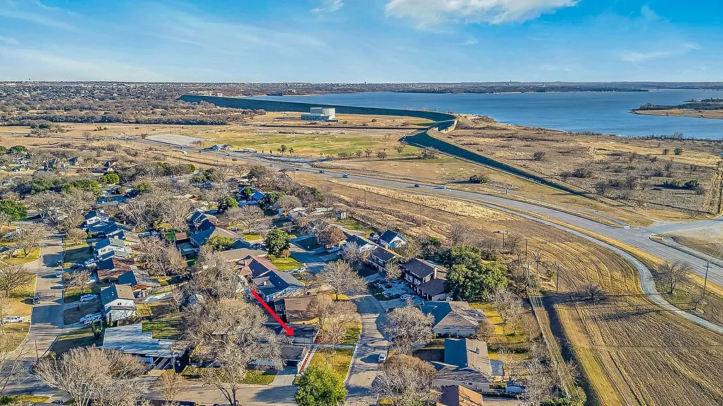 Aerial view of residential area featuring a large body of water