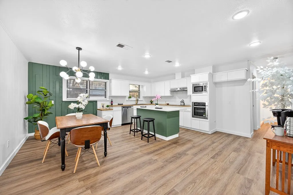 Dining area featuring light wood-type flooring and a chandelier
