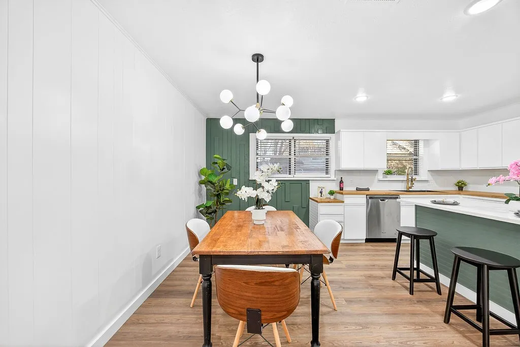 Dining area featuring light wood finished floors and a chandelier