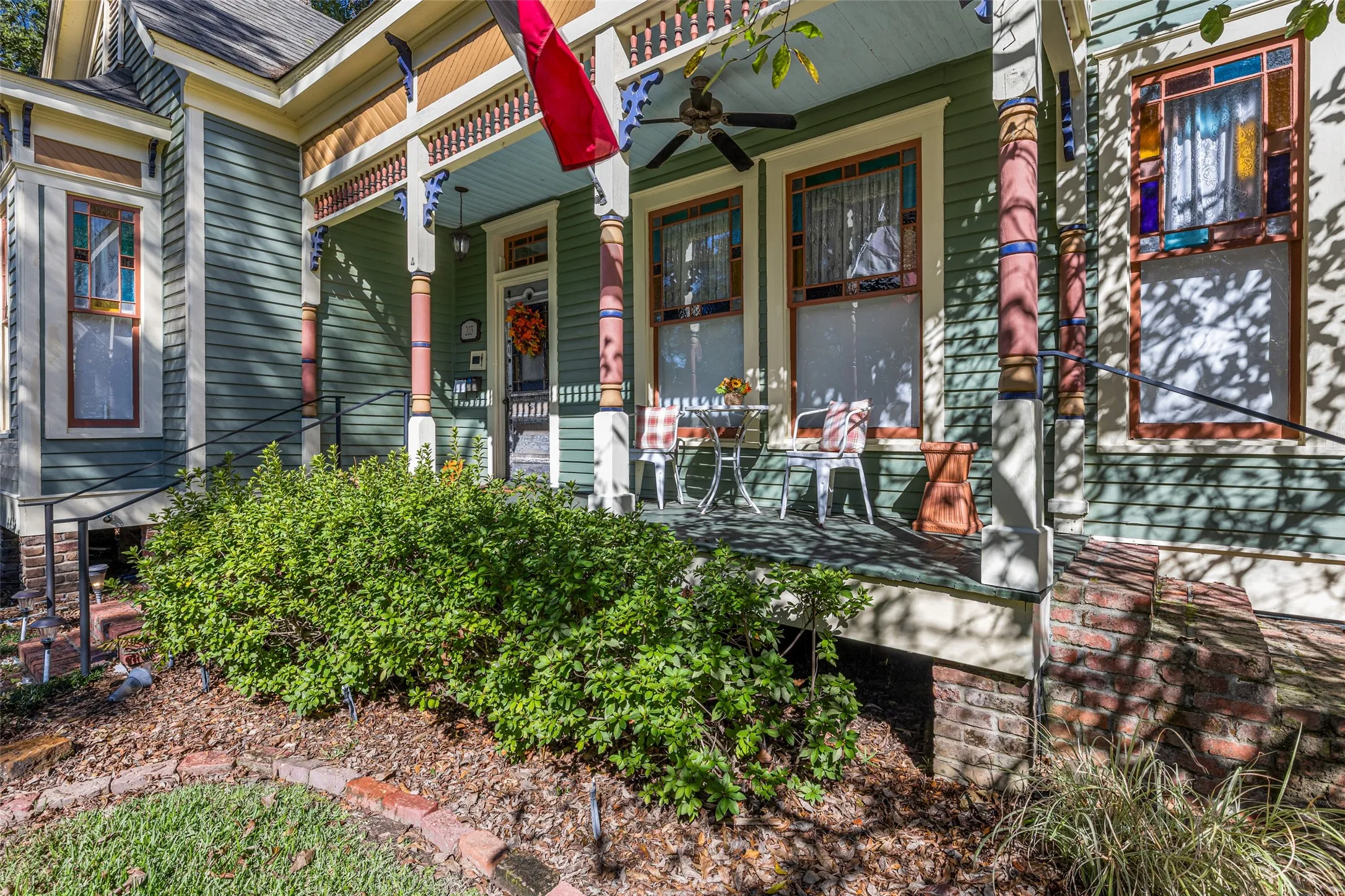 Front porch surrounded by Azaleas
