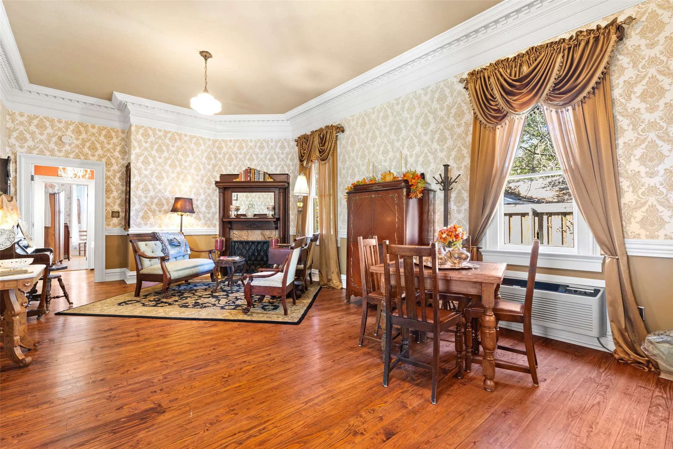 Living room parlor with view of fireplace and hardwoods